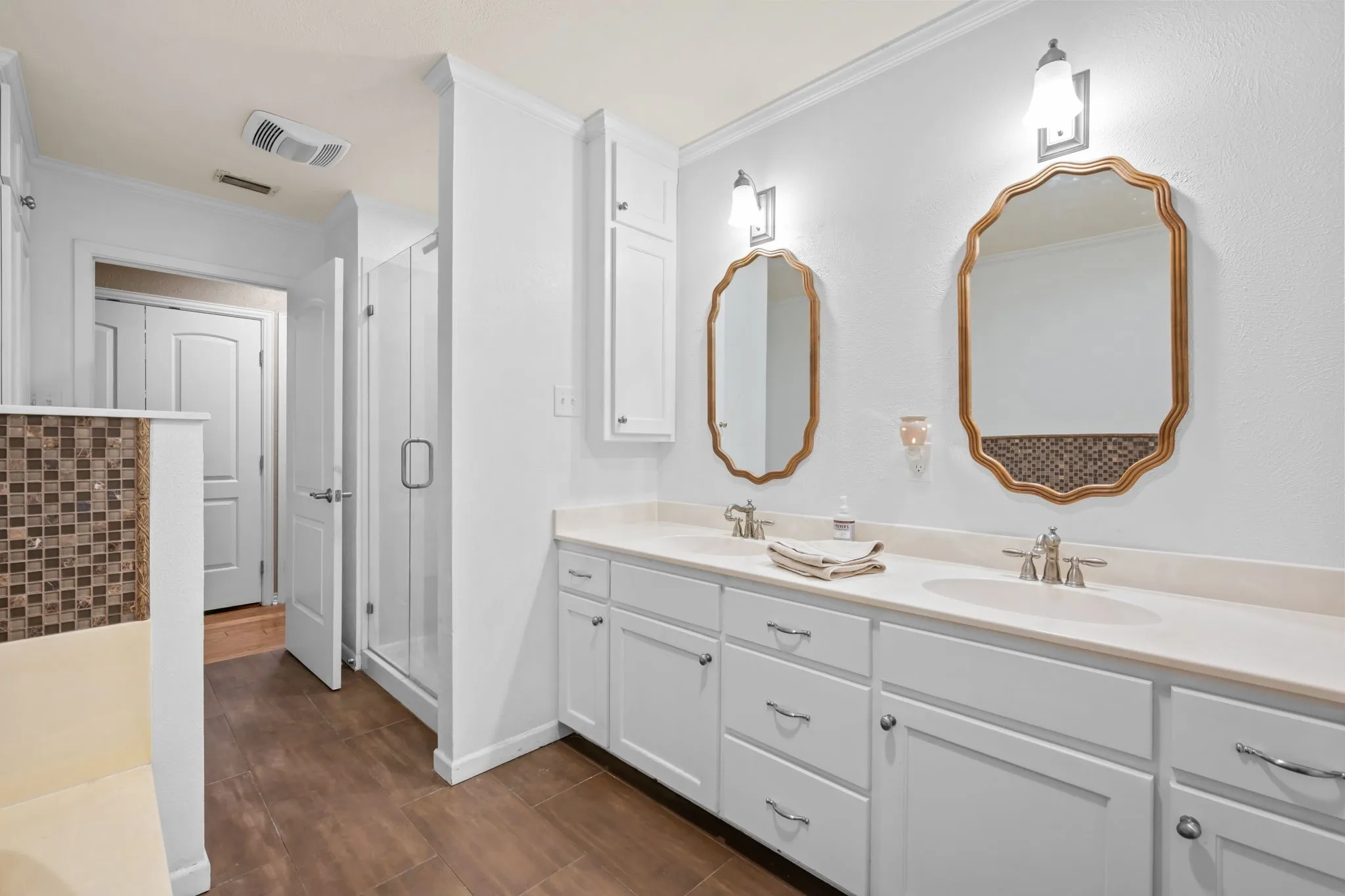 Dual vanity with undermount sinks, white cabinetry, and brushed nickel hardware