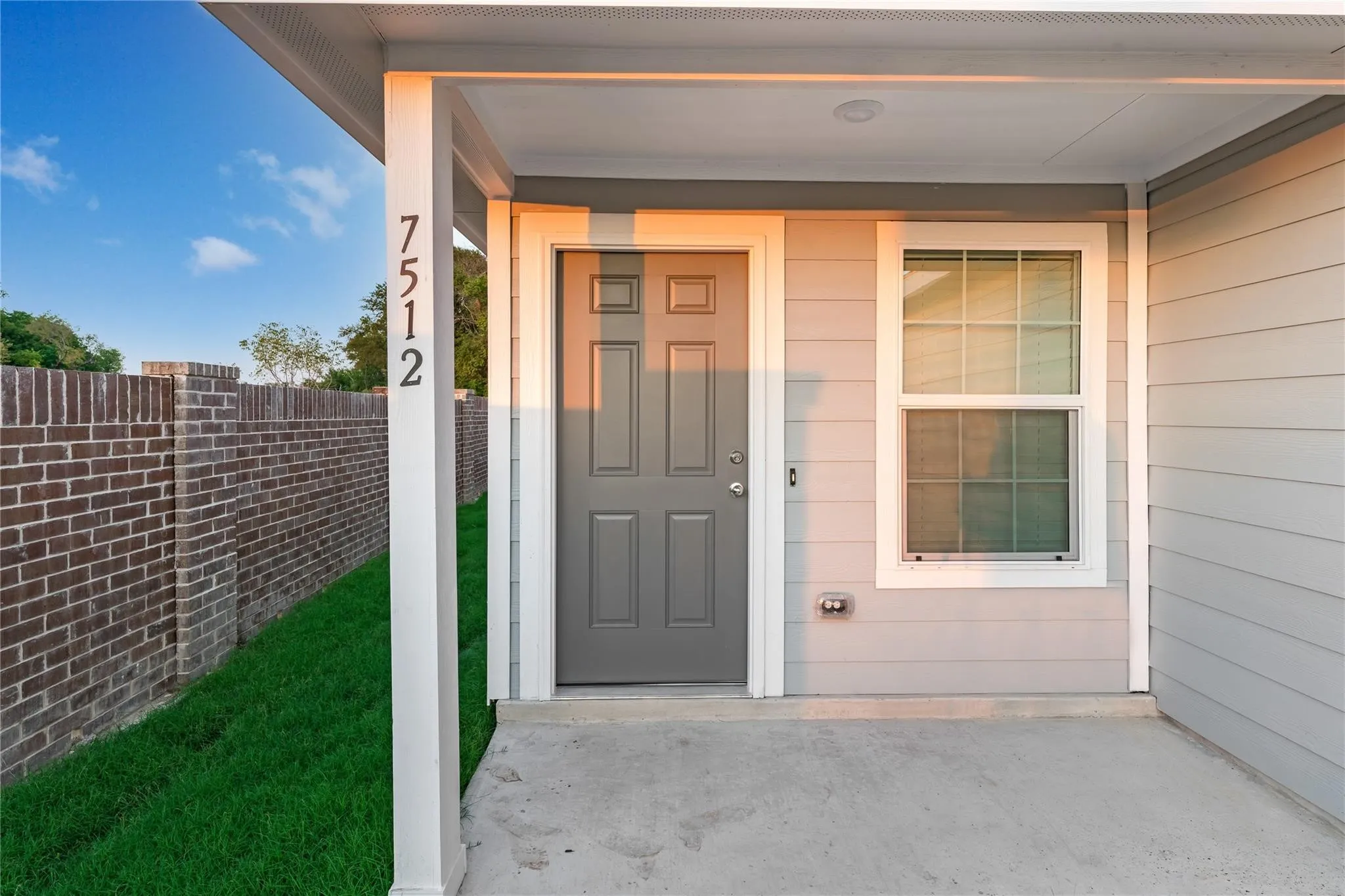 View of exterior entry featuring covered porch