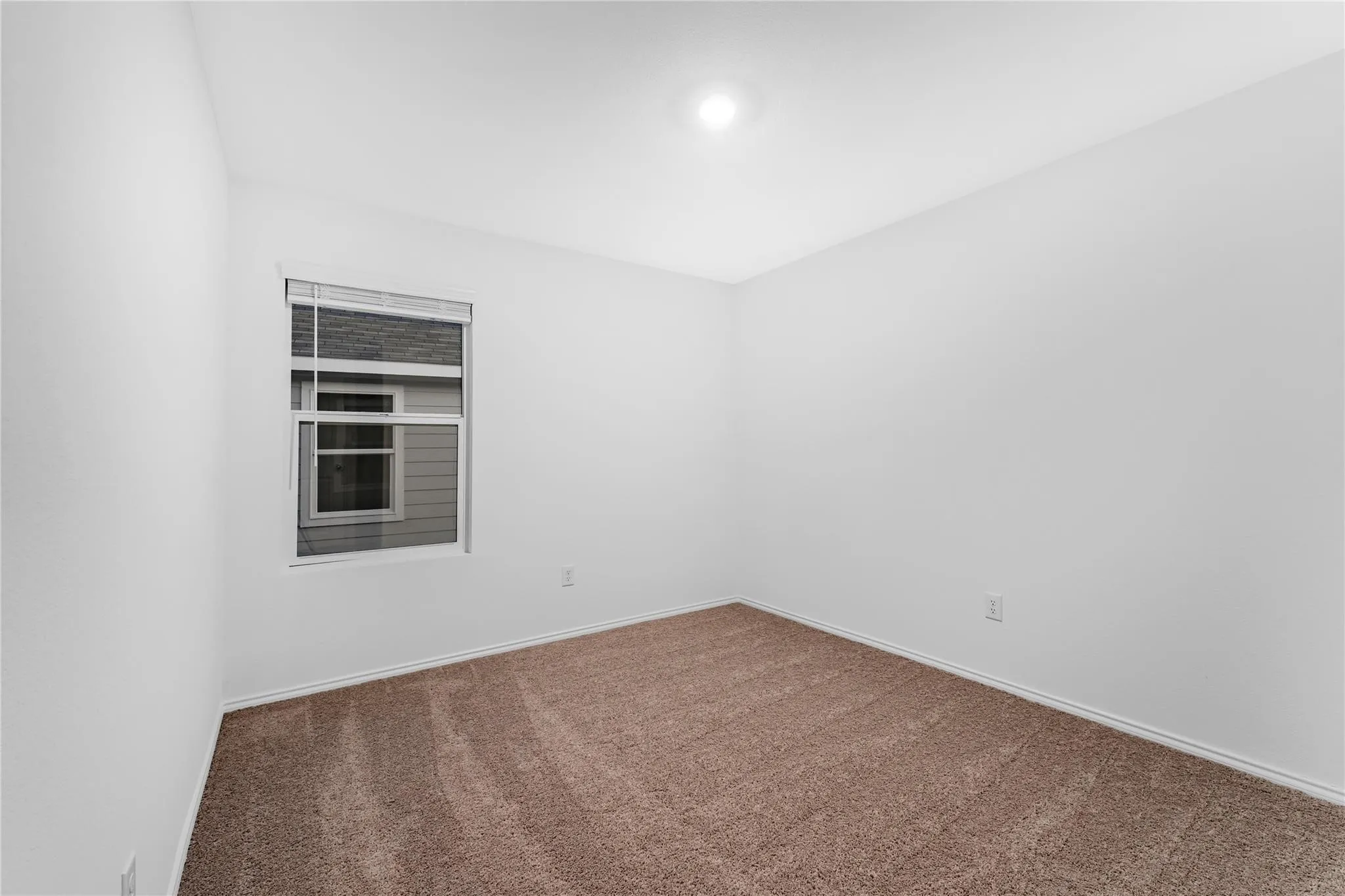 Unfurnished room featuring carpet and baseboards