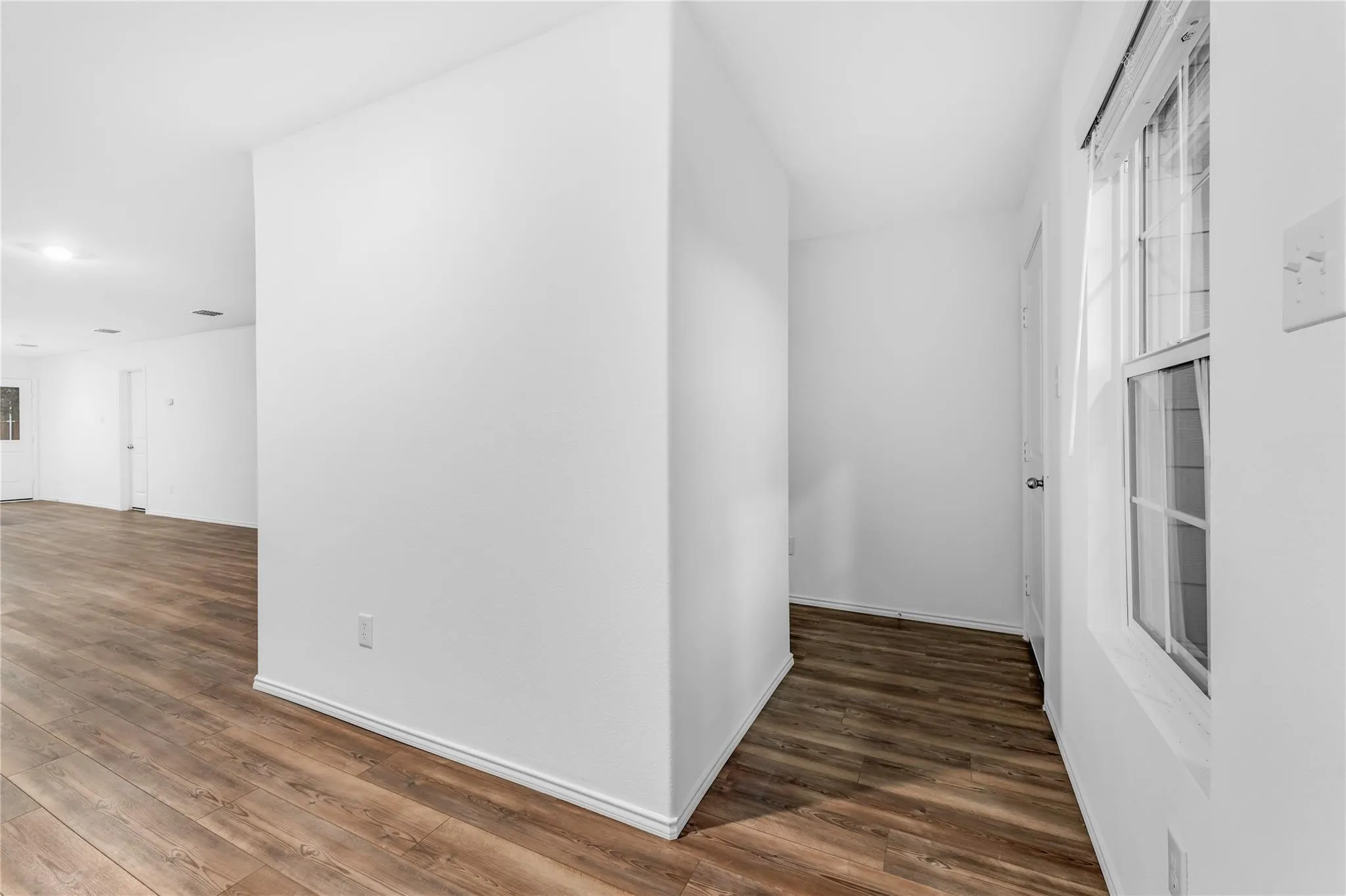 Corridor with dark wood-style floors