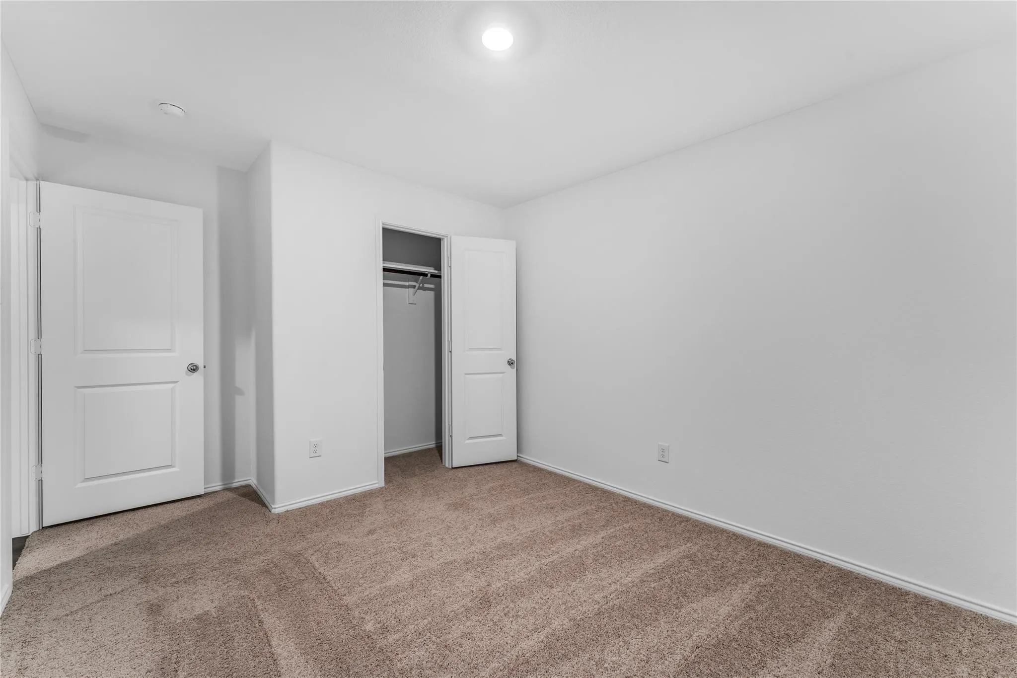 Unfurnished bedroom with carpet and a closet