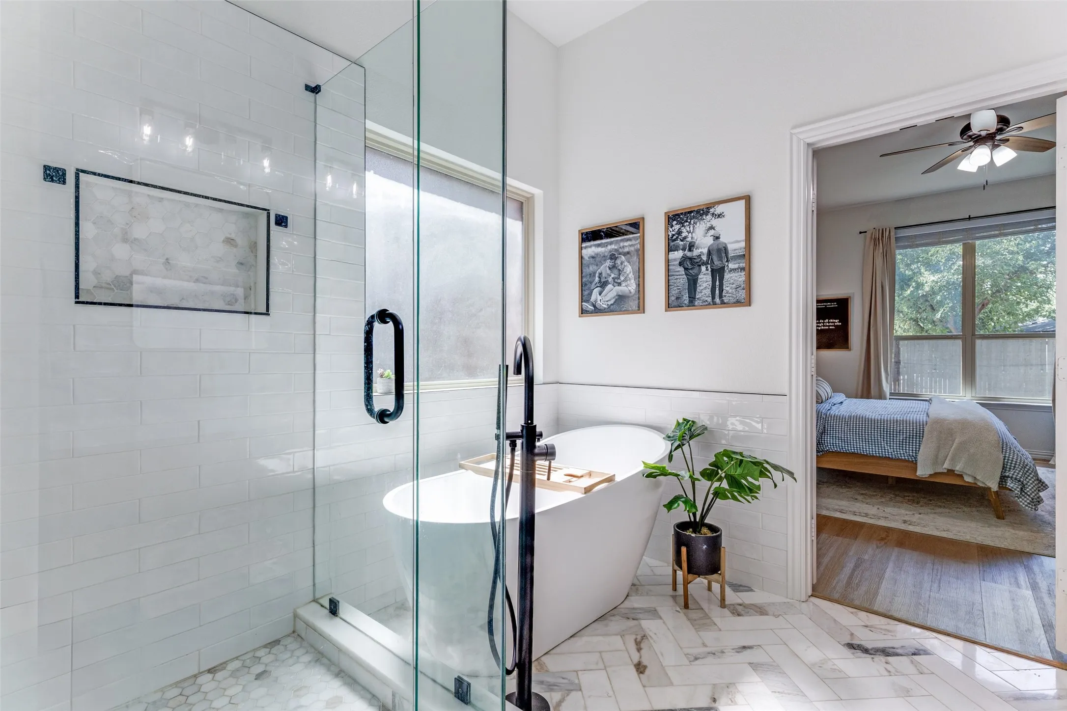 Walk-in shower with hexagonal tile floor, subway tile surround, and built-in niche