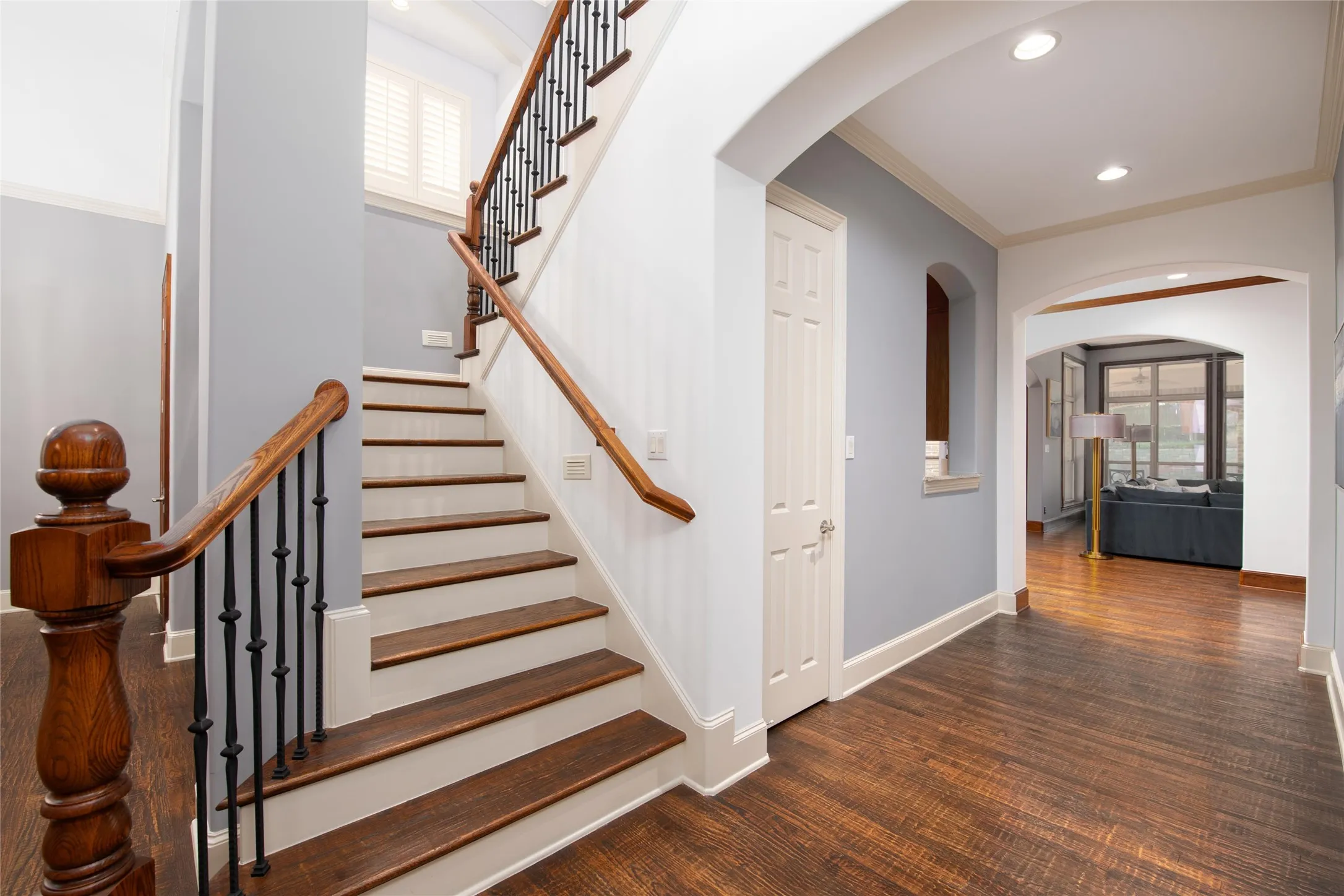 Hand-scraped hardwoods continue up the staircase and through the upstairs landing and hallway, creating a cohesive custom finish between both levels.