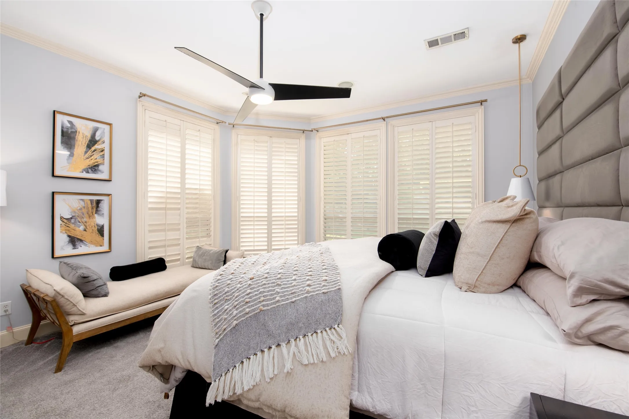 A second view of the primary suite showcases its generous scale, calming neutral finishes and abundant windows.