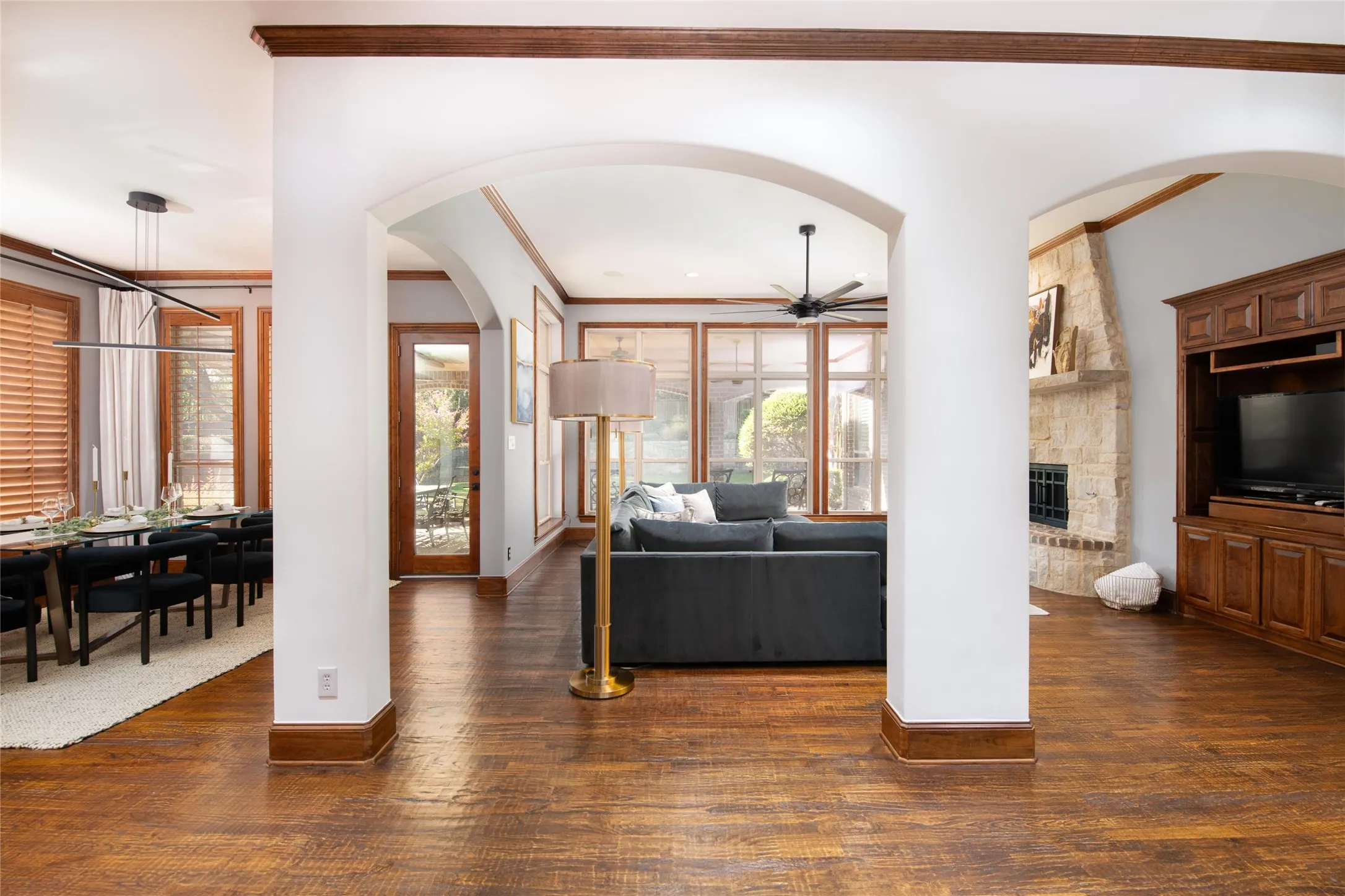 Graceful arches, detailed millwork and abundant natural light create an inviting connection between the main living and entertaining spaces.