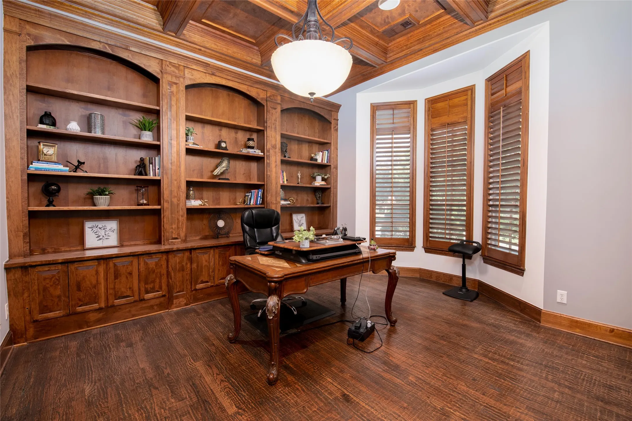 Rich floor-to-ceiling cabinetry provides impressive storage and display space while giving the private study the character expected in a custom-built home.