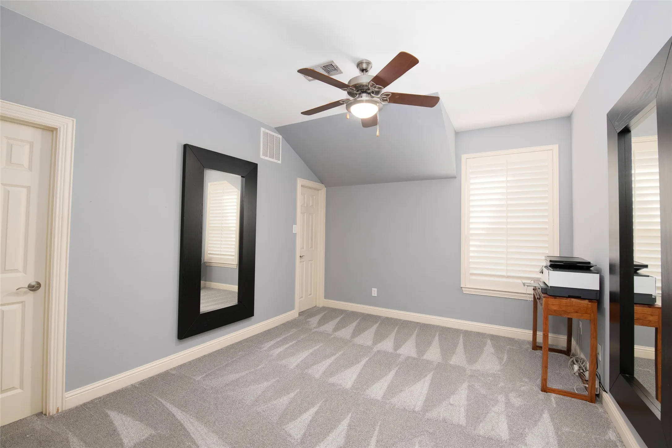 One of five bedrooms, this spacious secondary bedroom offers neutral finishes and flexibility for family or guests.