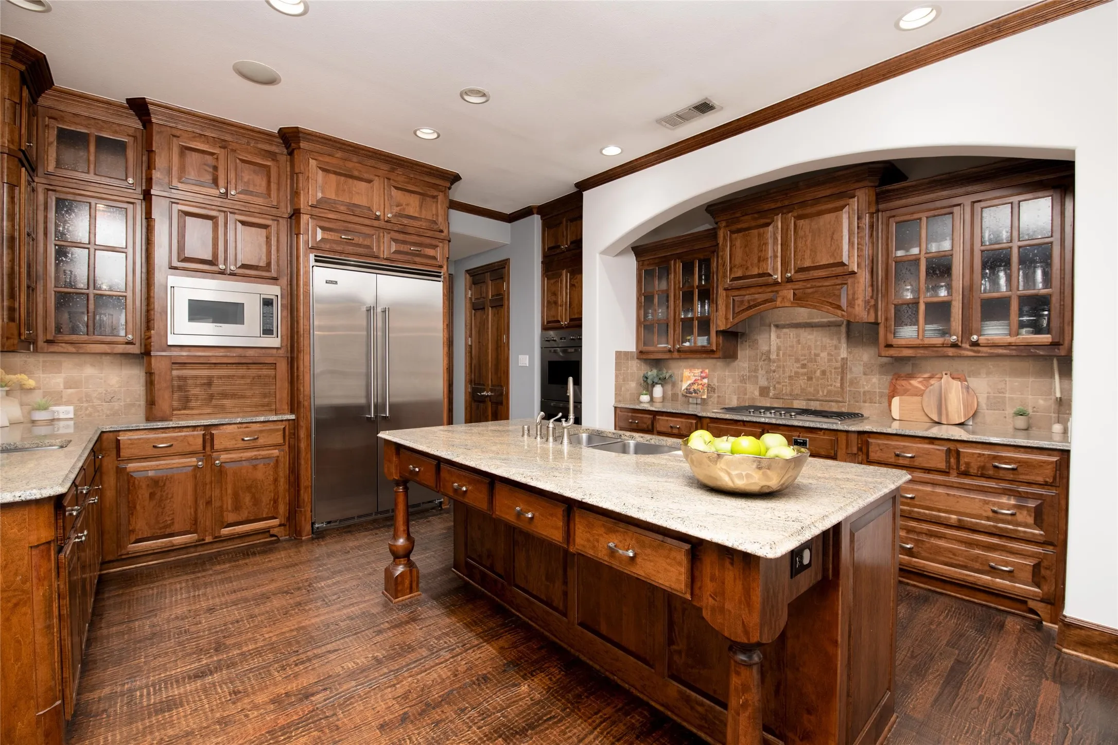 A second island view highlights the vegetable sink, beautiful cabinetry and convenient layout that makes cooking and entertaining effortless.