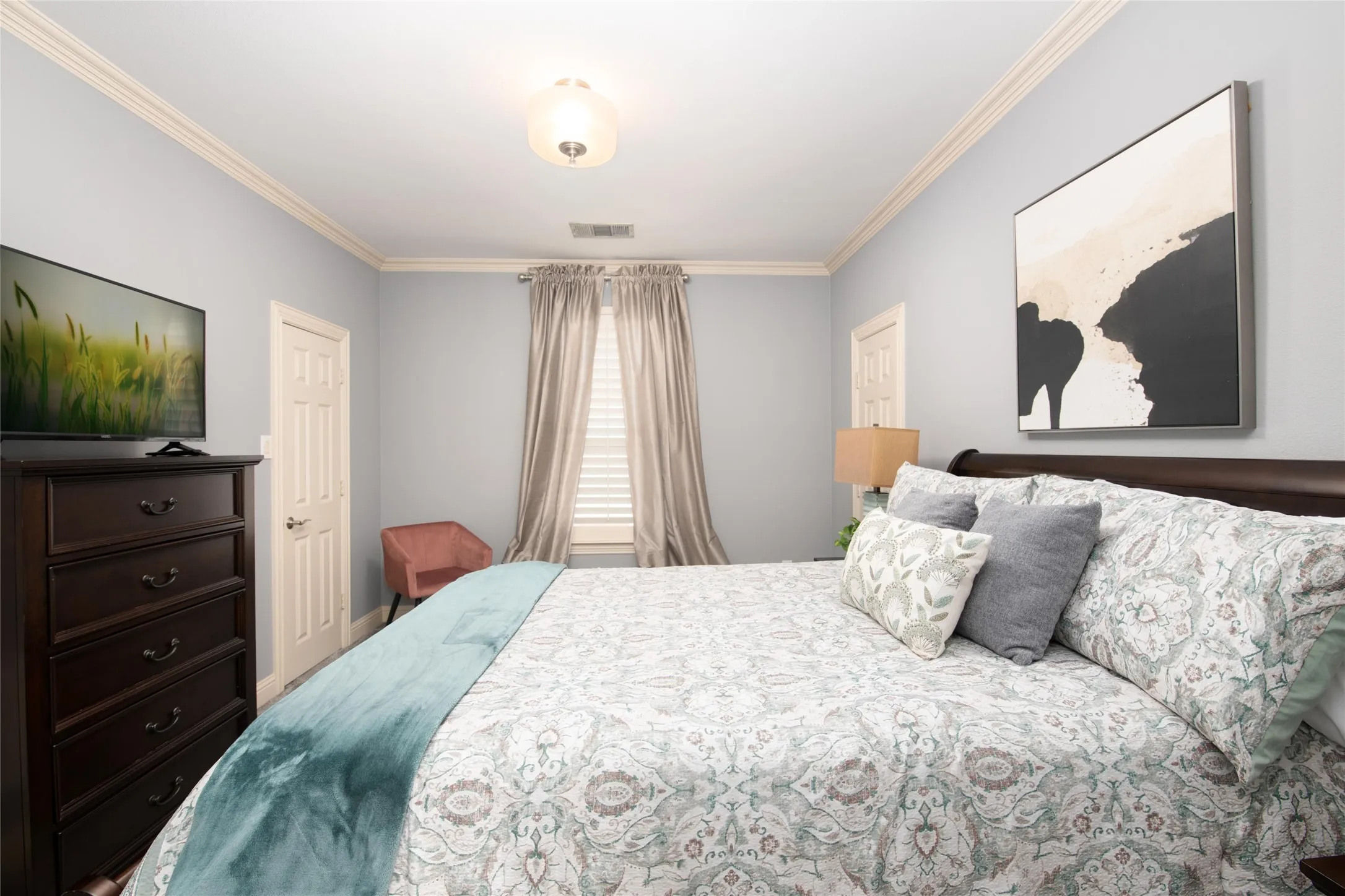 One of five bedrooms, this comfortable secondary suite offers plenty of space—and every bedroom in the home includes a walk-in closet.