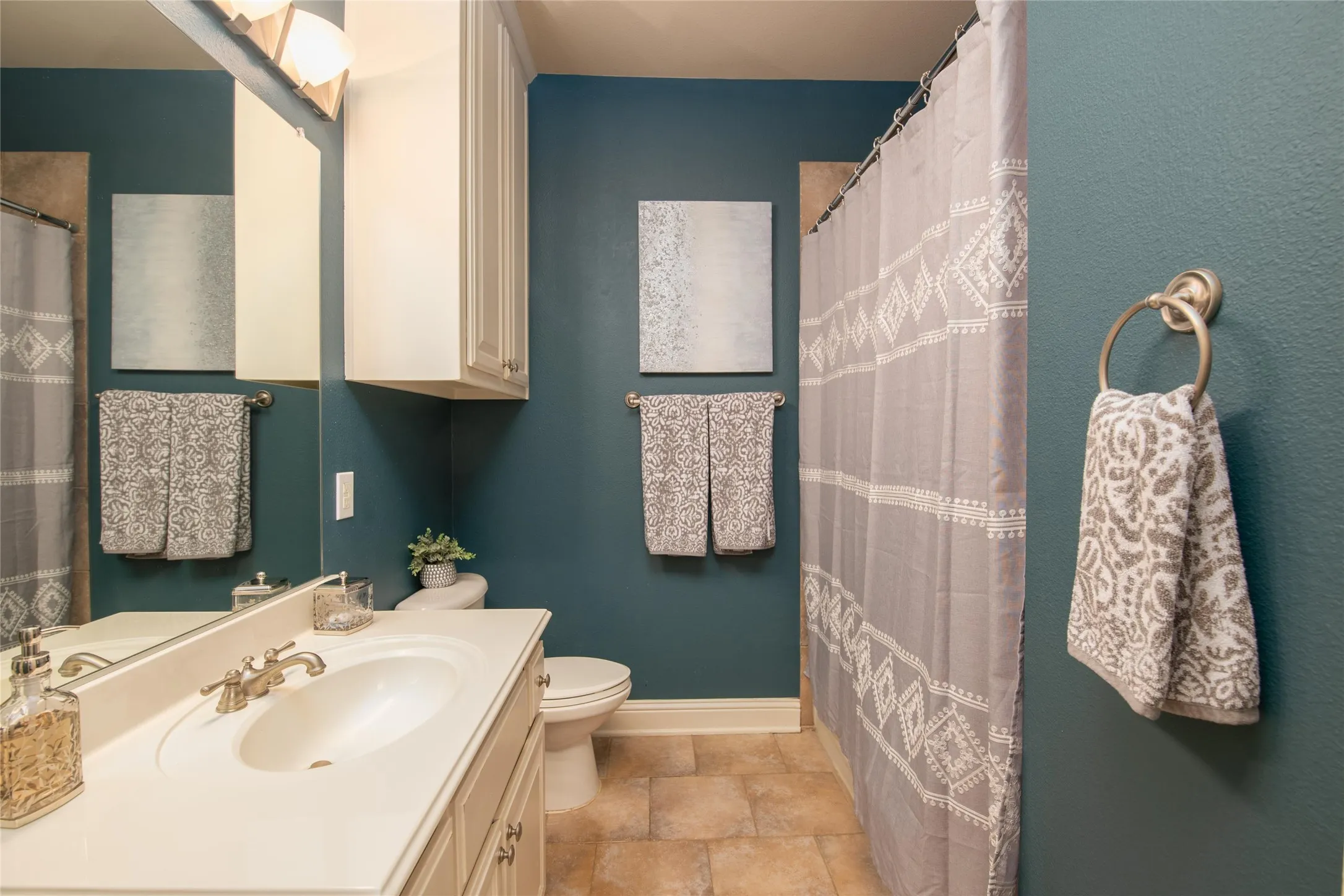 A stylish secondary bath offers a bright vanity area and a polished, updated look.
