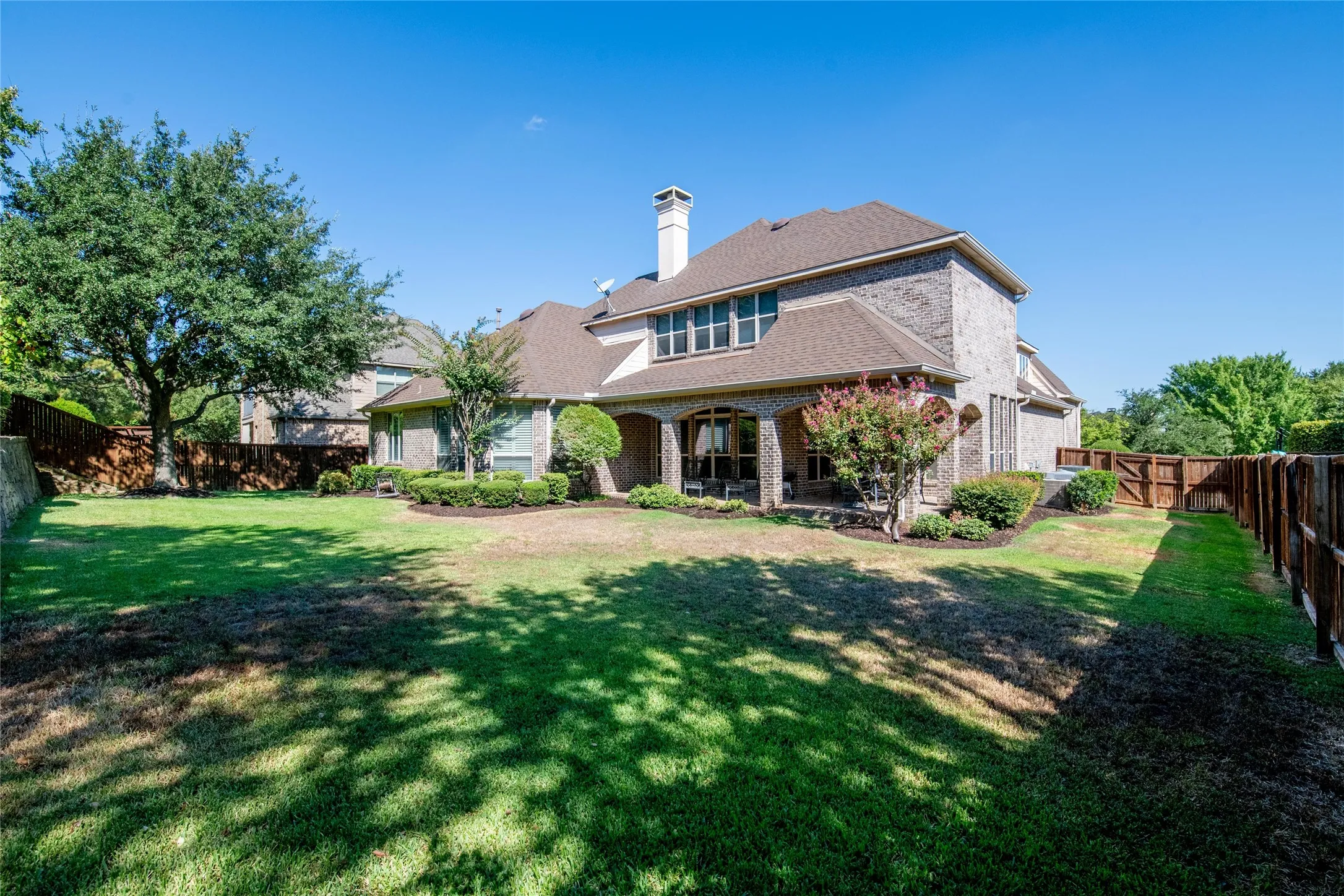 Mature landscaping and a generous lawn enhance the privacy of the backyard while providing plenty of room to enjoy the outdoors.
