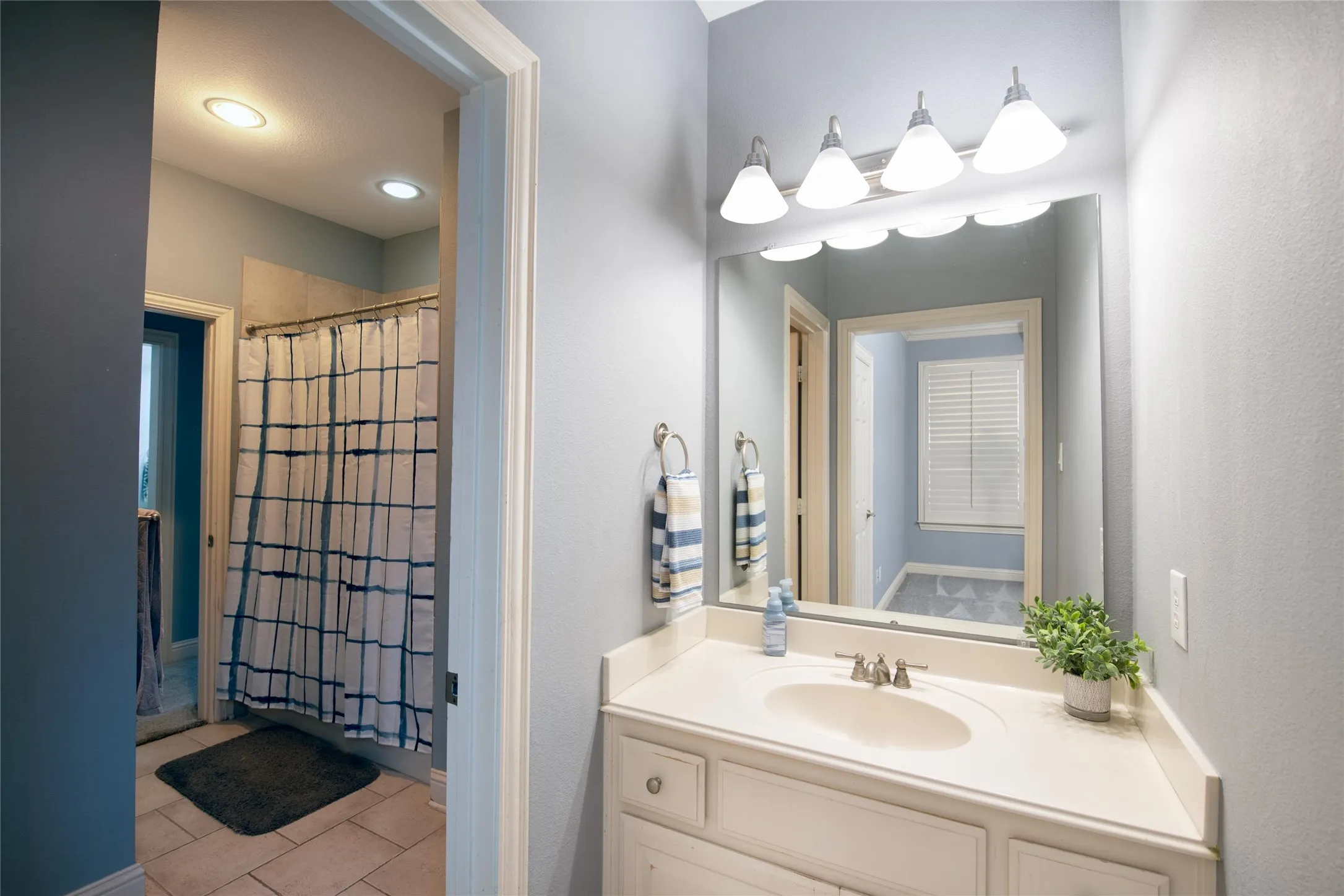 A well-appointed secondary bath provides a convenient vanity area and separate tub/shower space.
