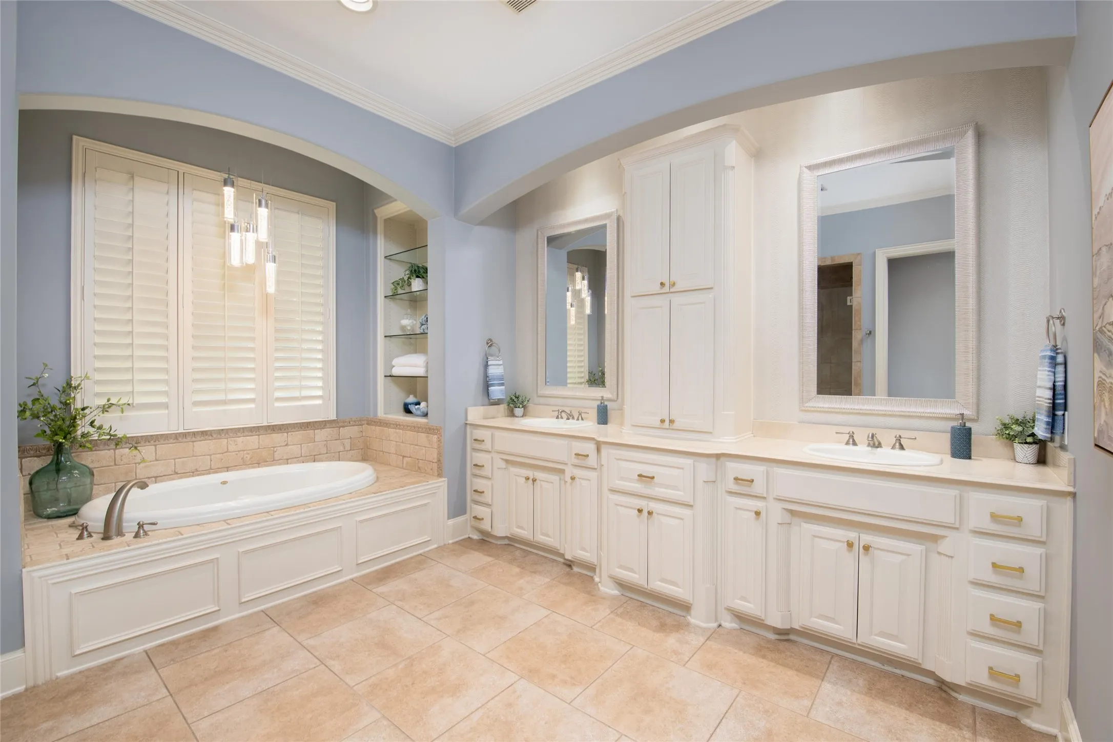 The primary bath features an expansive dual-sink vanity, abundant cabinetry and a large soaking tub for a true retreat-like feel.