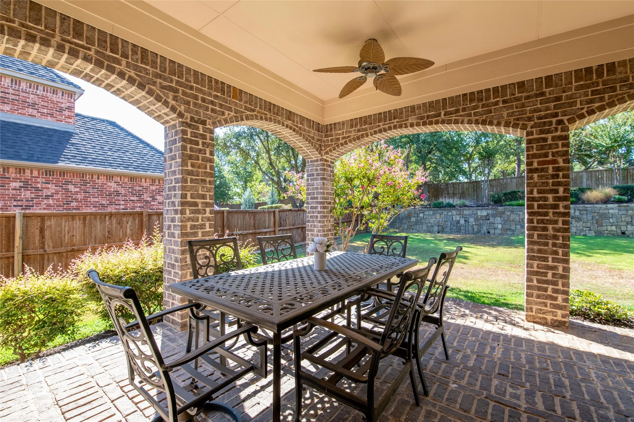 A large covered patio creates an inviting outdoor living area overlooking the private backyard—perfect for relaxing or entertaining.