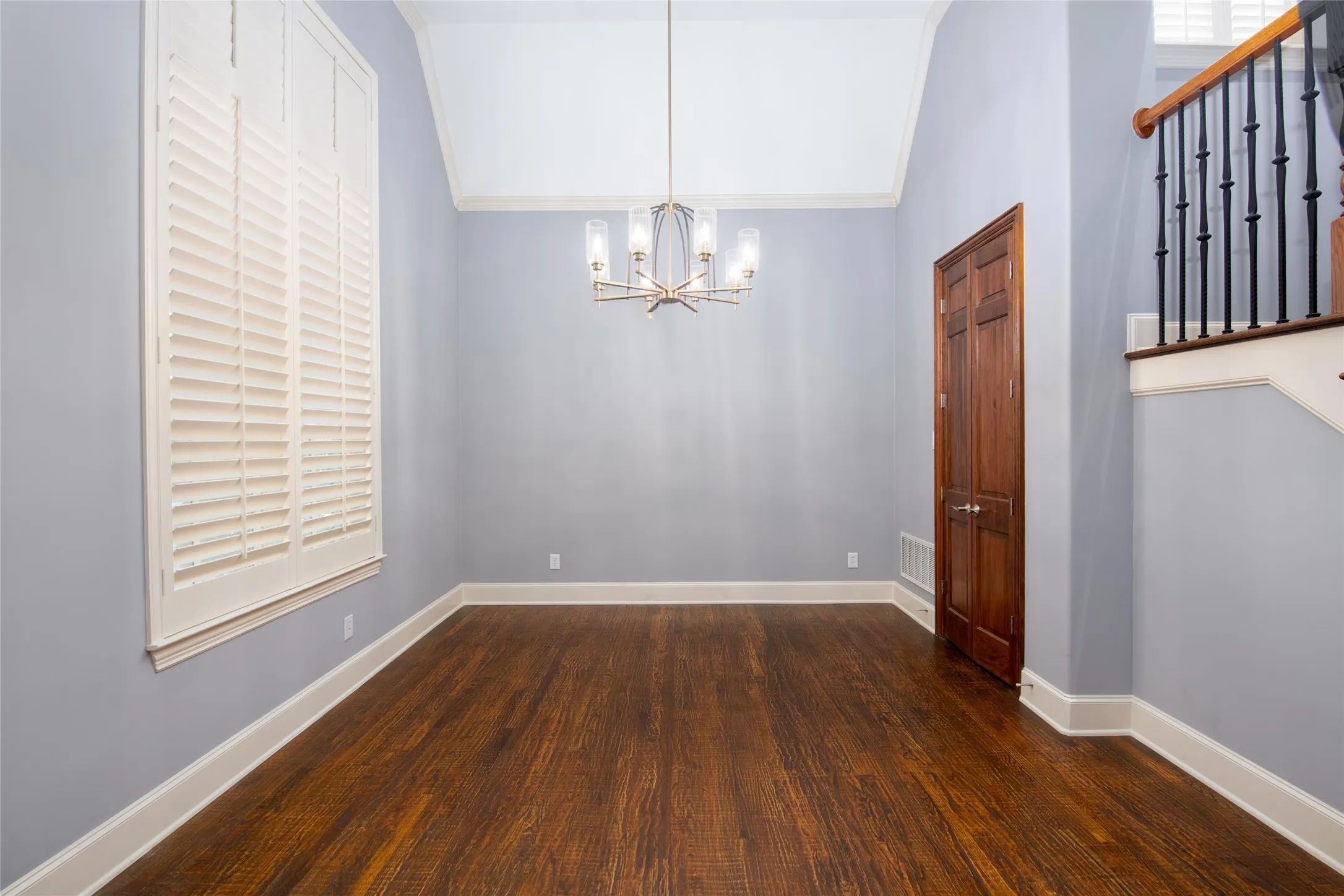 The formal dining room provides an elegant setting for gatherings, enhanced by hardwood flooring and updated lighting.