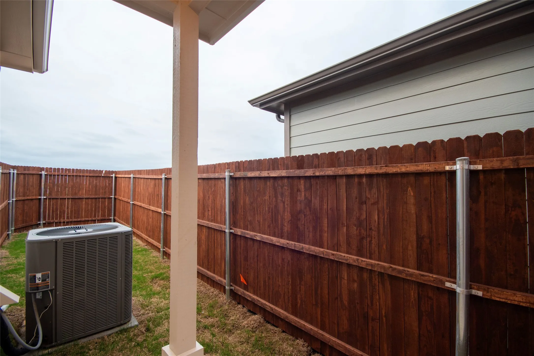 View of yard with central AC unit and a fenced backyard