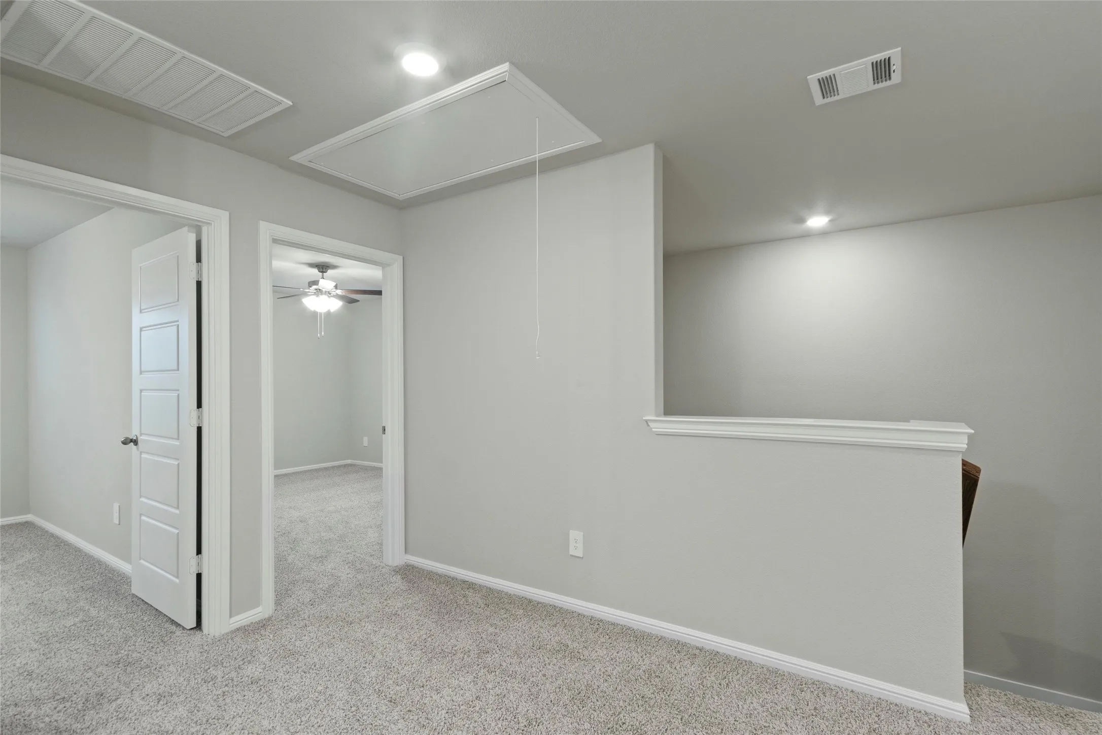  Upstairs area featuring carpet, visible vents, and recessed lighting