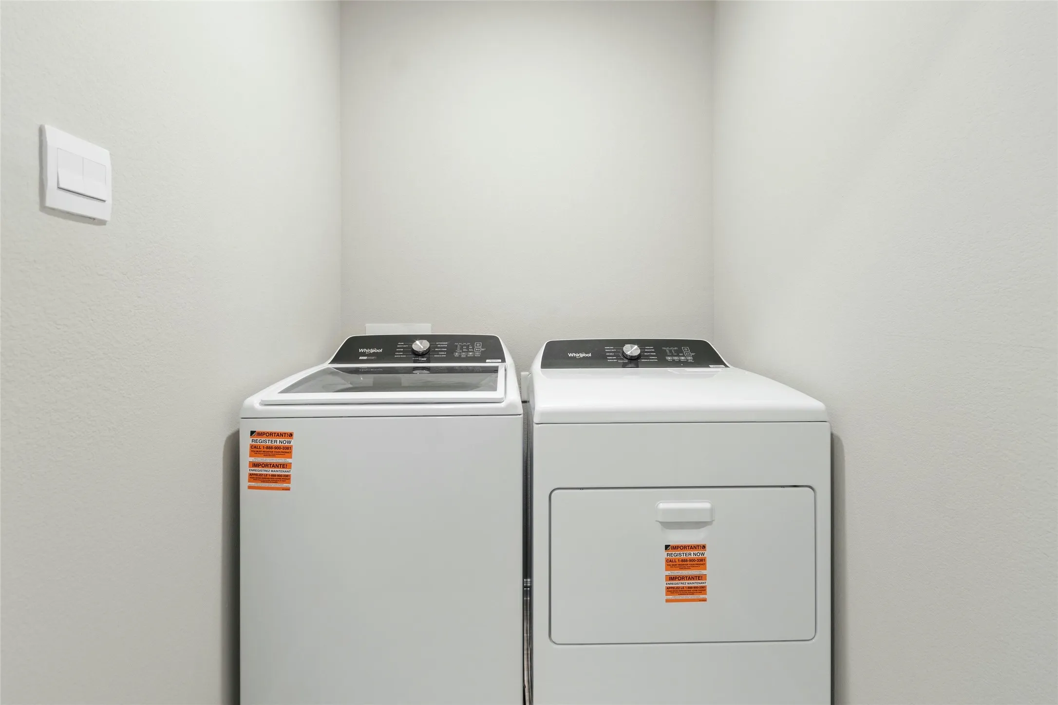 Washroom featuring washing machine and dryer and laundry area