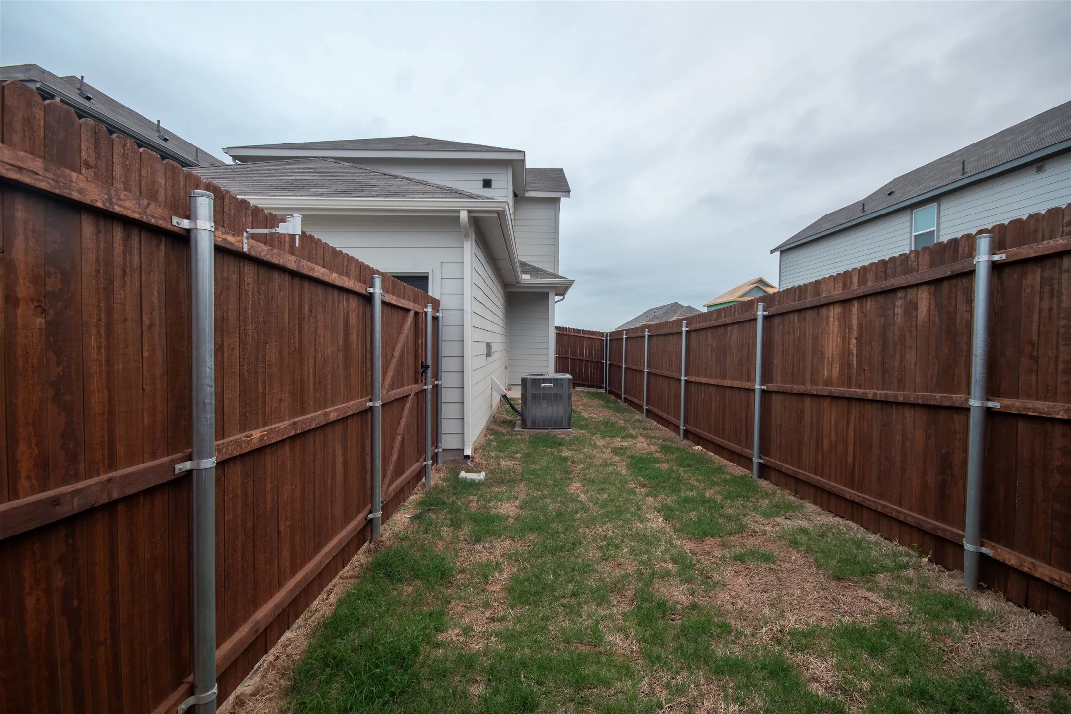 View of yard featuring central air condition unit and a fenced backyard