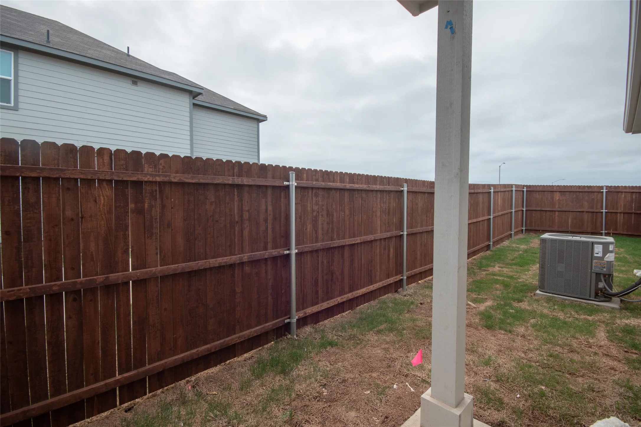 View of yard featuring a fenced backyard and cooling unit