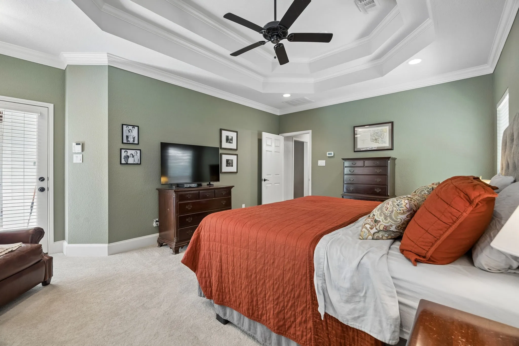 Primary Bedroom featuring Tray ceiling with recessed lighting and crown molding
