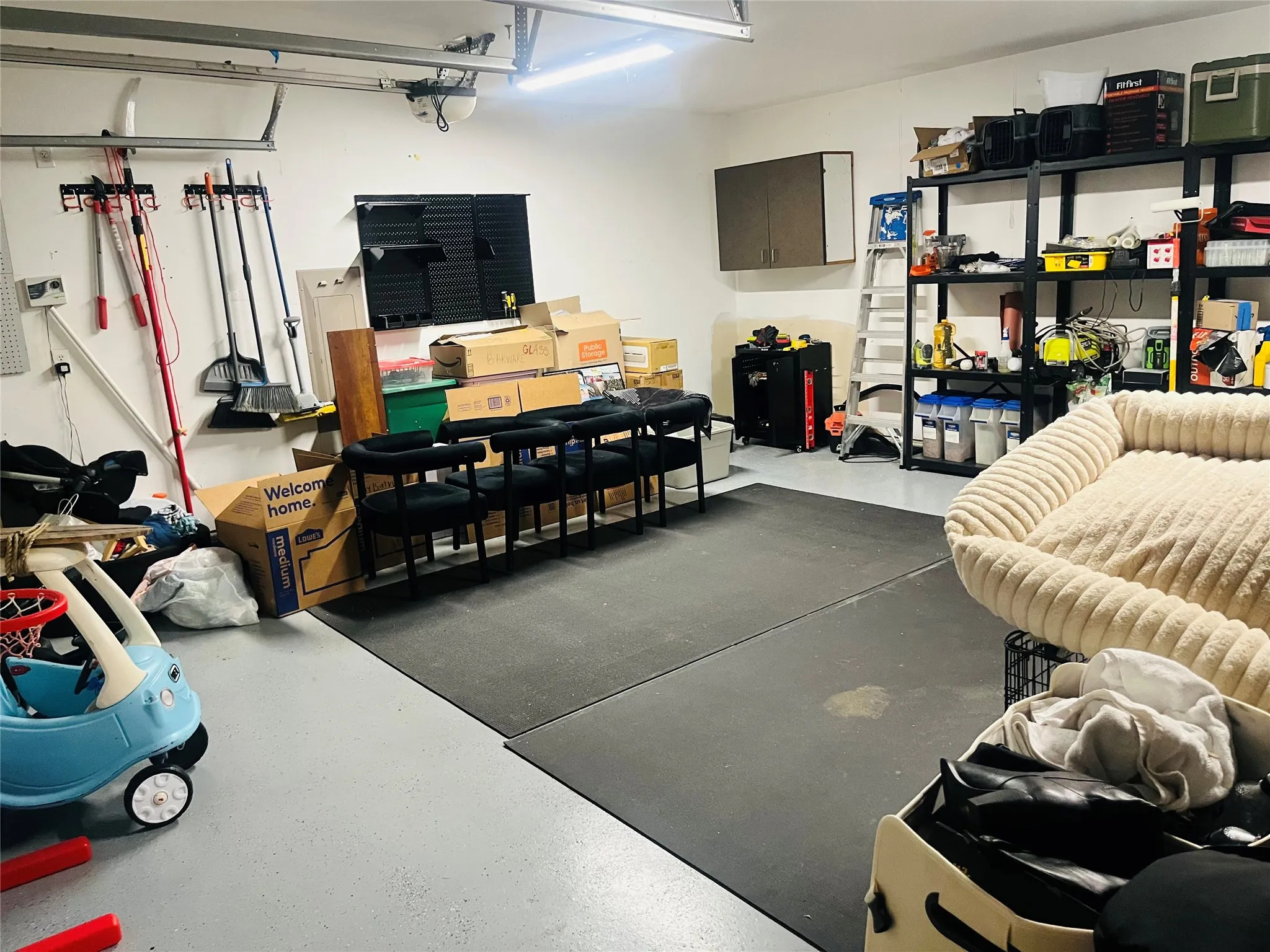 Oversized 2 car garage features epoxy flooring and built-in shelving!
