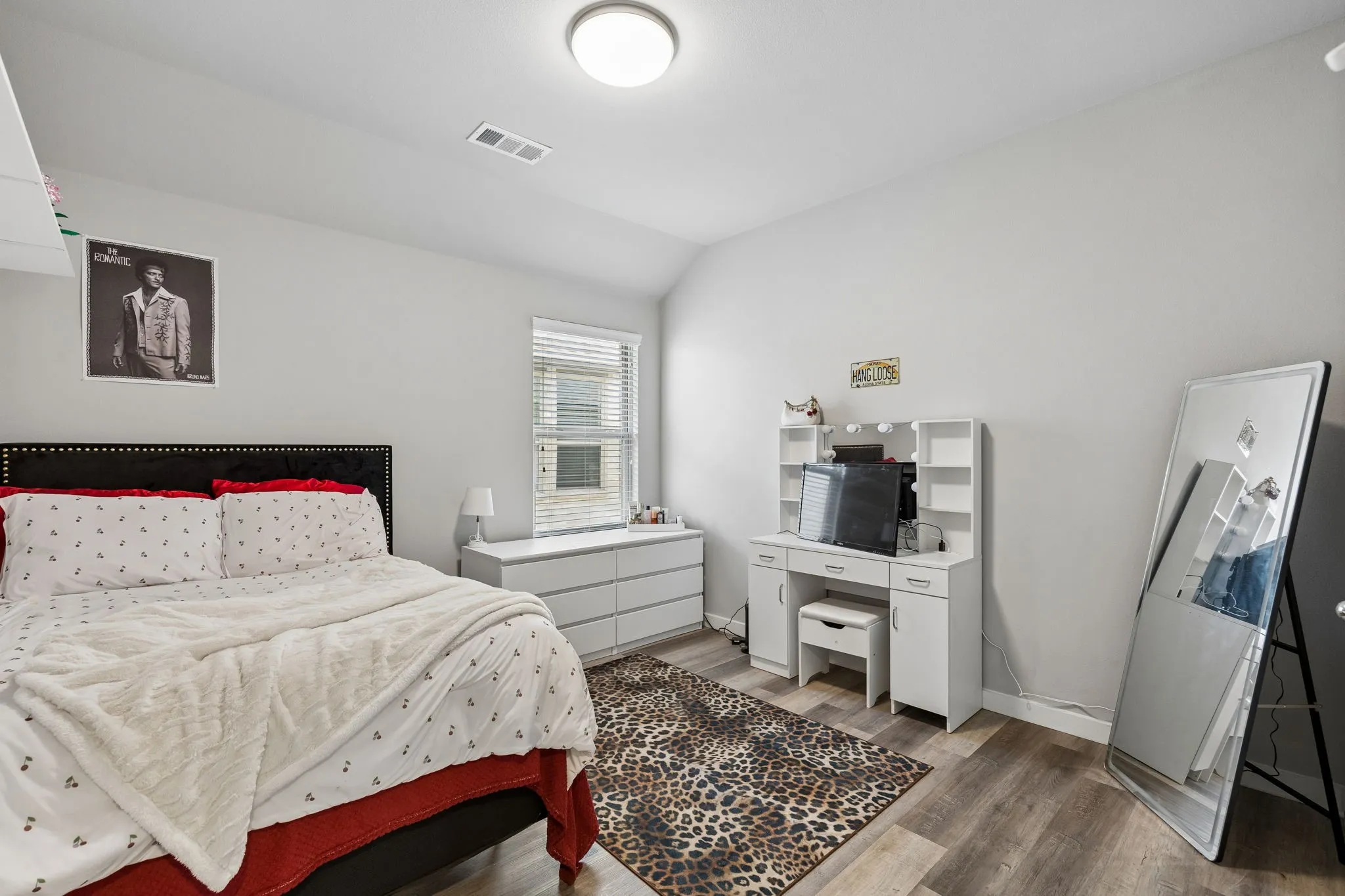 Wood-finish flooring with light gray wall paint and a recessed window