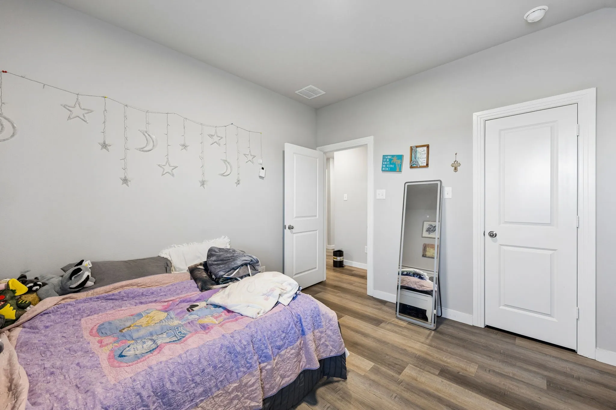 Wood-finish flooring with light-toned walls and white trim