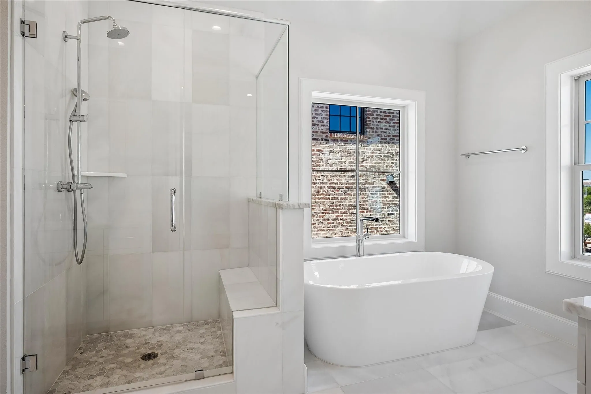 Frameless glass shower enclosure with a built-in bench