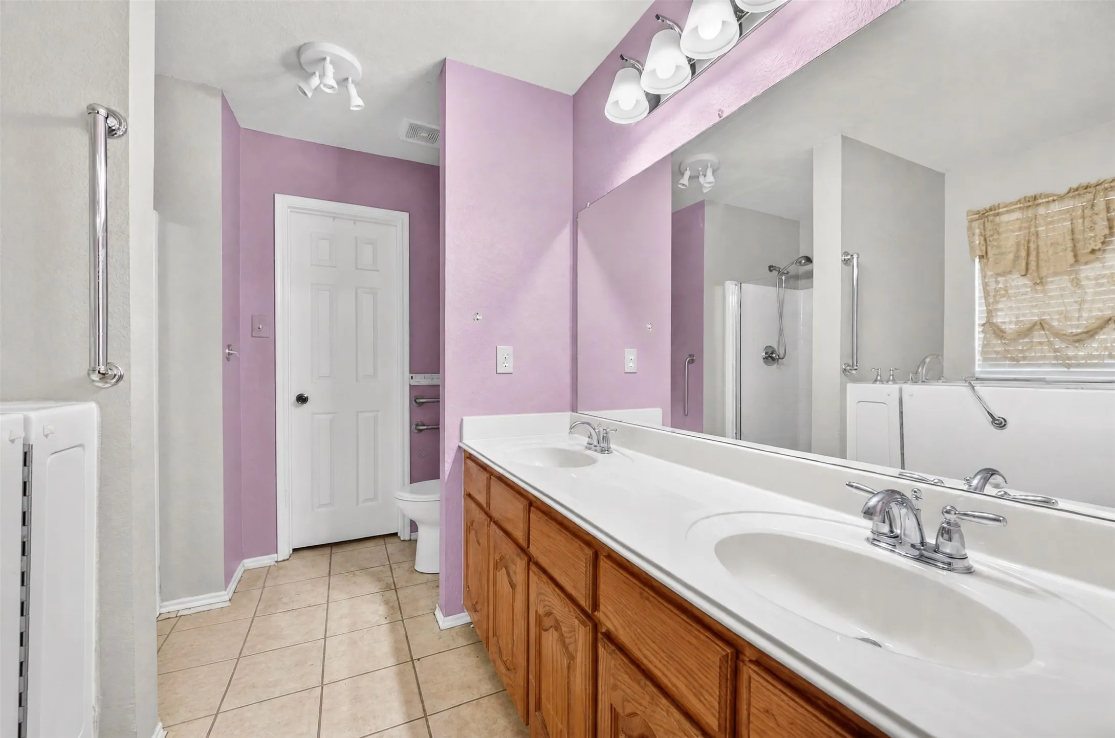 Dual sinks, separate shower, grab bars, walk-in whirlpool tub, and bidet