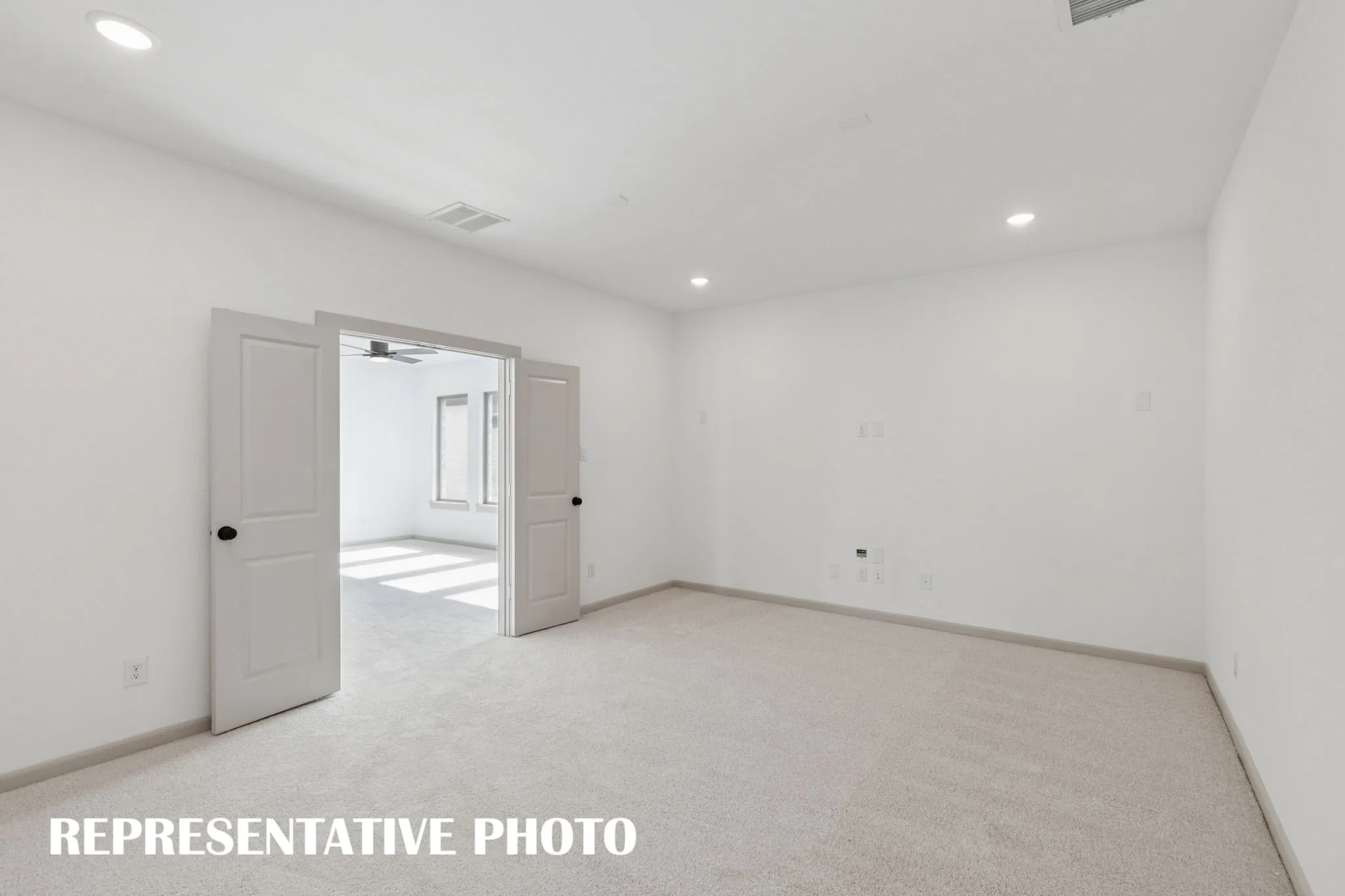 The grand media room adjacent to the light filled game room create the ultimate family entertainment area.  REPRESENTATIVE PHOTO