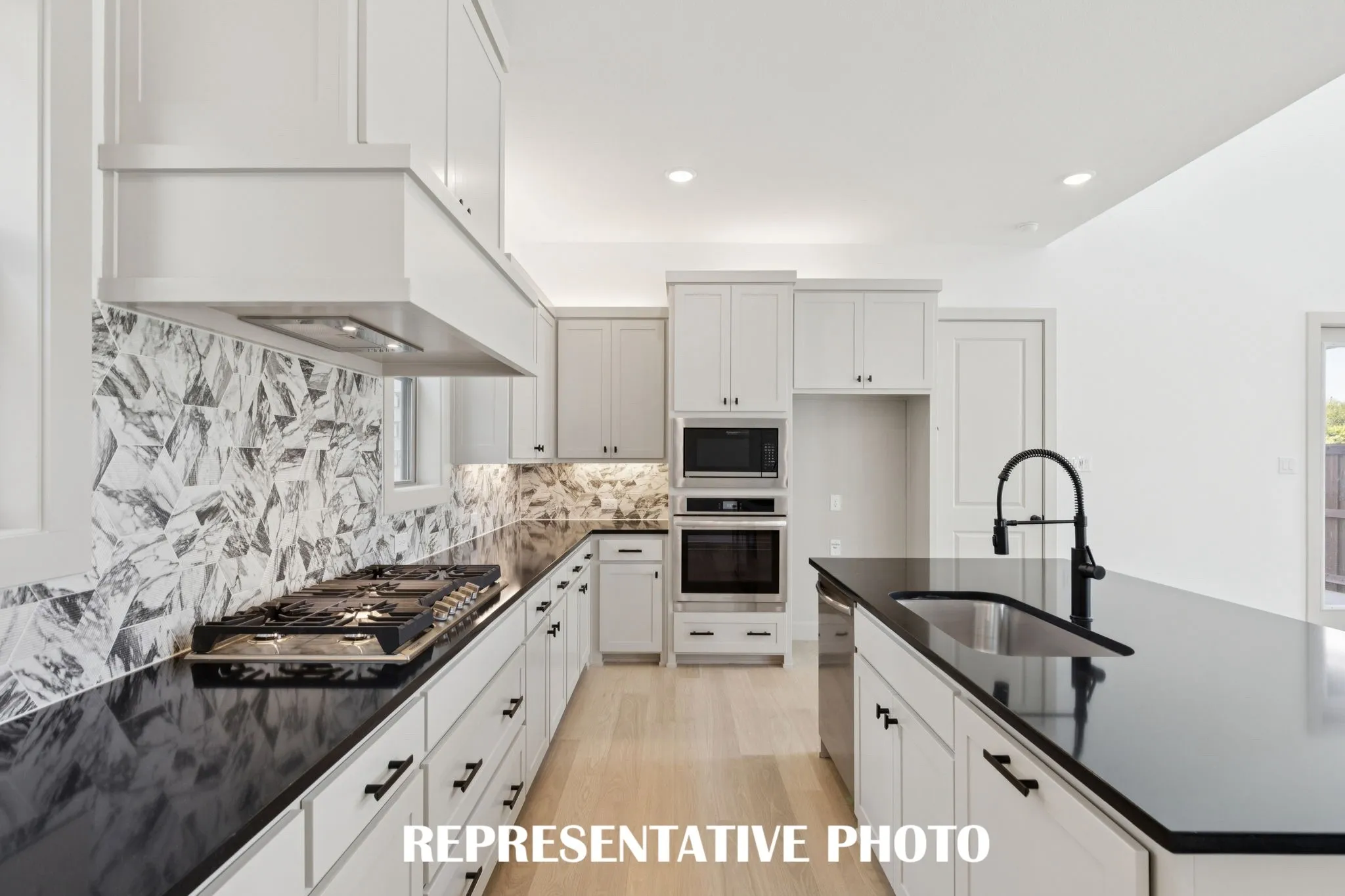 The chef will never be left out of the party in this fantastic open concept dream home!  REPRESENTATIVE PHOTO