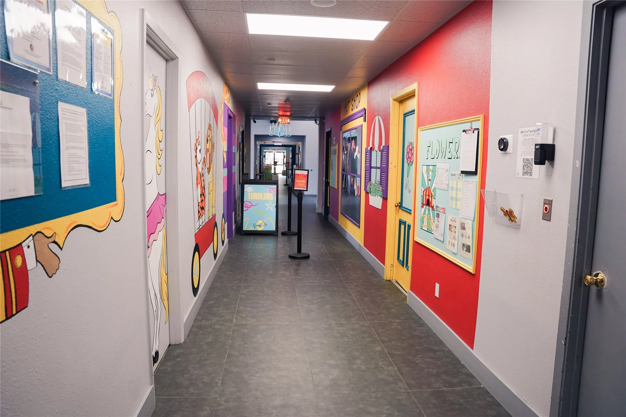 Hallway featuring vibrant wall murals, recessed lighting, and tile flooring