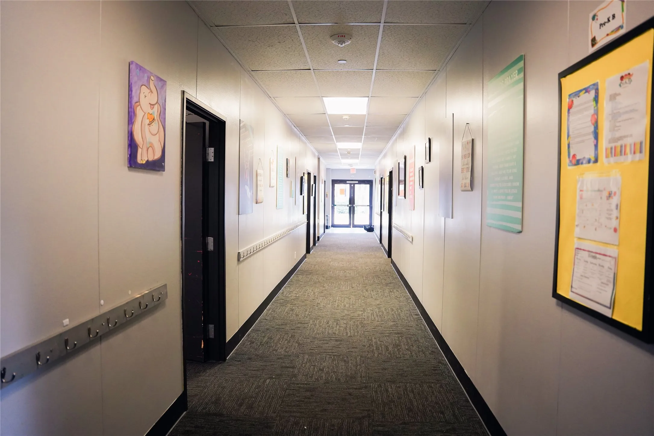 Long corridor featuring neutral walls