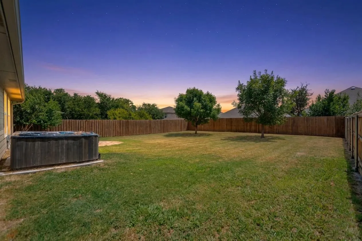 Twilight view of back yard.