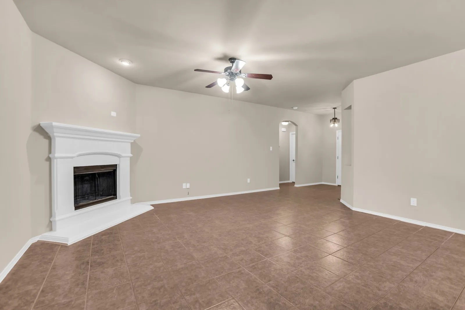 Living area featuring a white mantel fireplace, tile flooring, a ceiling fan, and recessed lighting