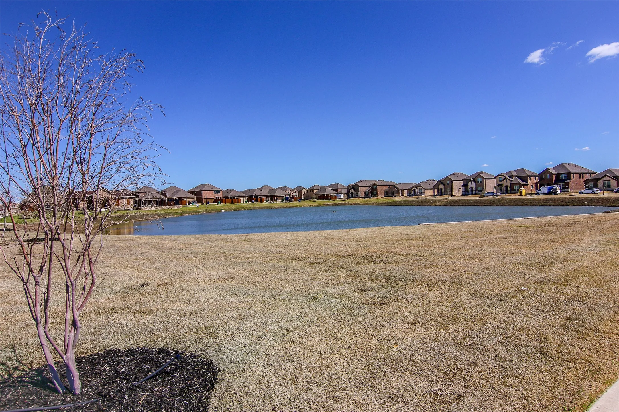 Expansive pond with surrounding residential properties