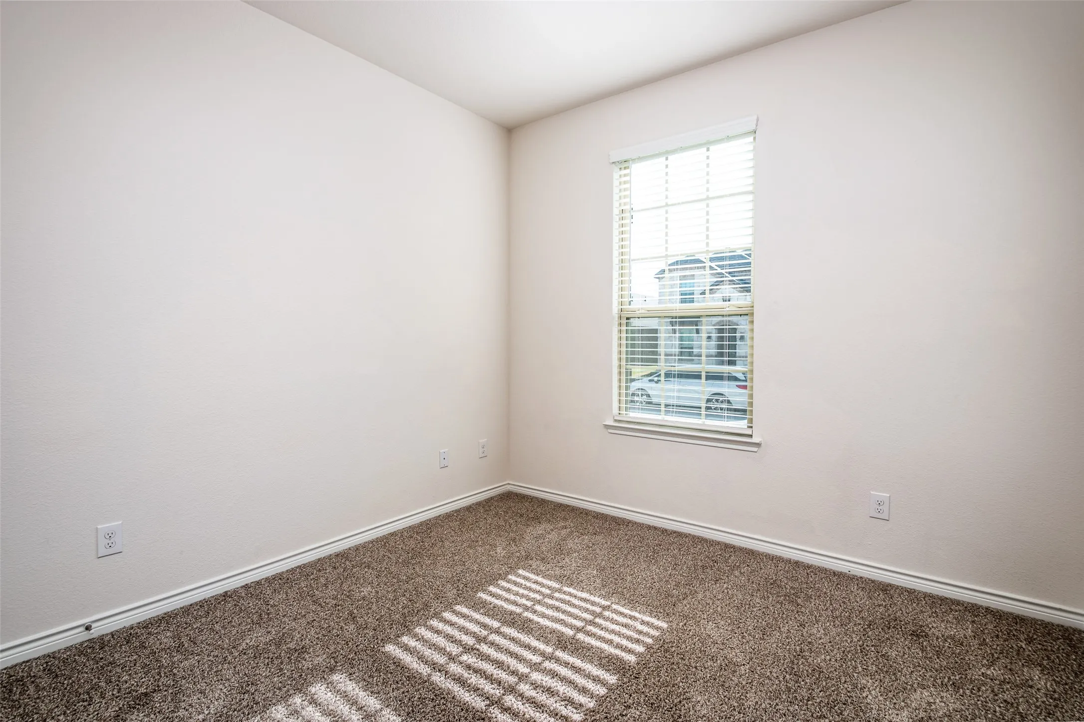 Neutral wall finishes and carpeted flooring