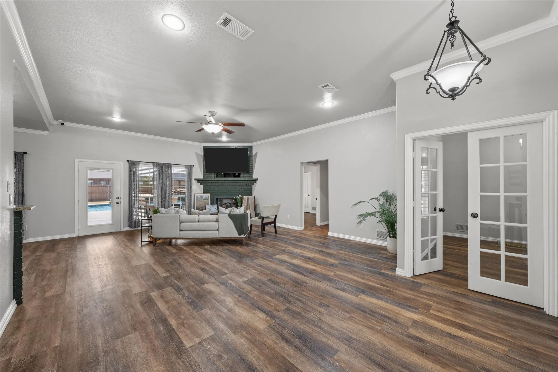 Wood-finish flooring throughout, recessed lighting, and crown molding
