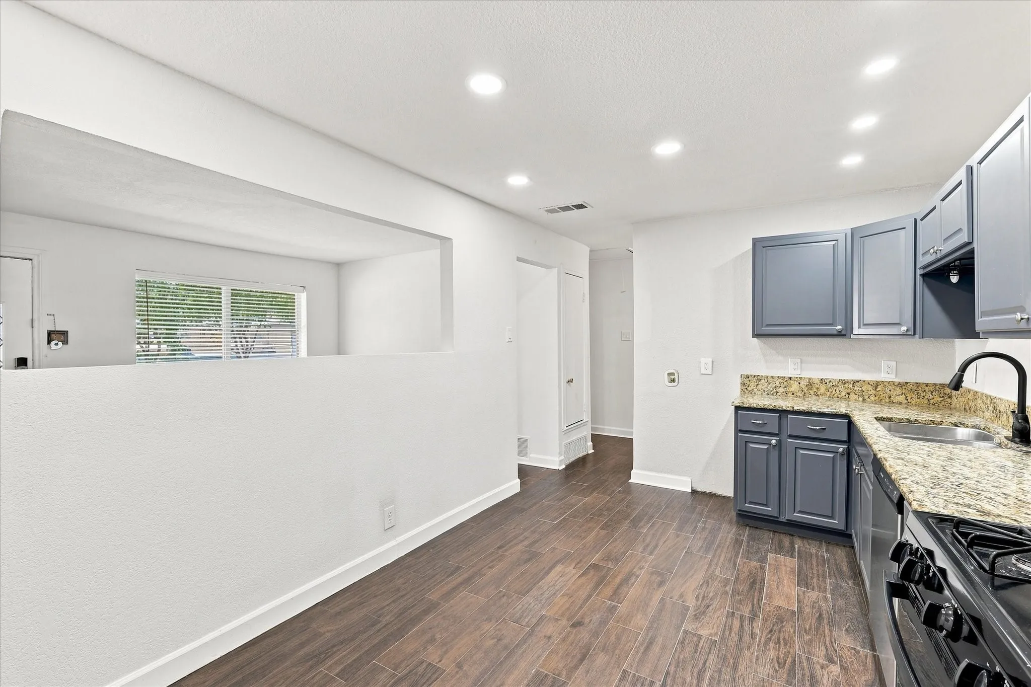 Updated kitchen with granite countertops, led lights, painted cabinets, stainless steel vent and gas range with pot filler.
