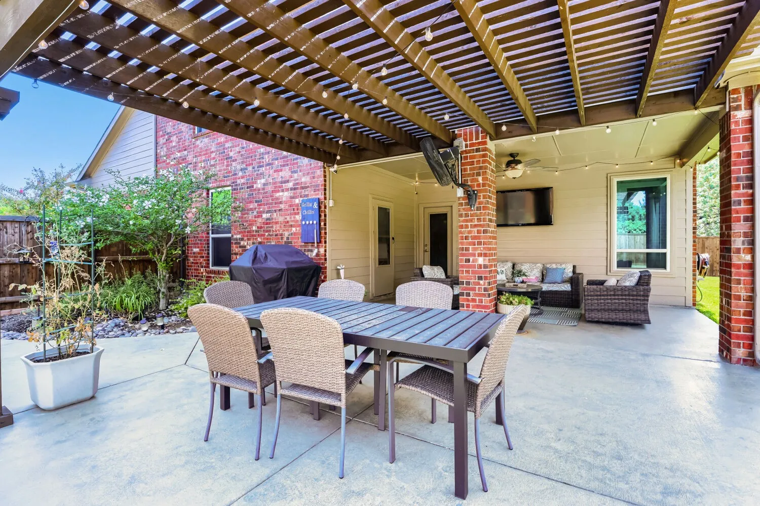 Extended 400-square-foot patio featuring a custom pergola.