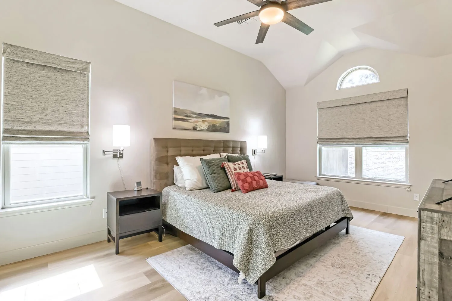 This primary bedroom features abundant natural light and a custom Elfa storage closet system.