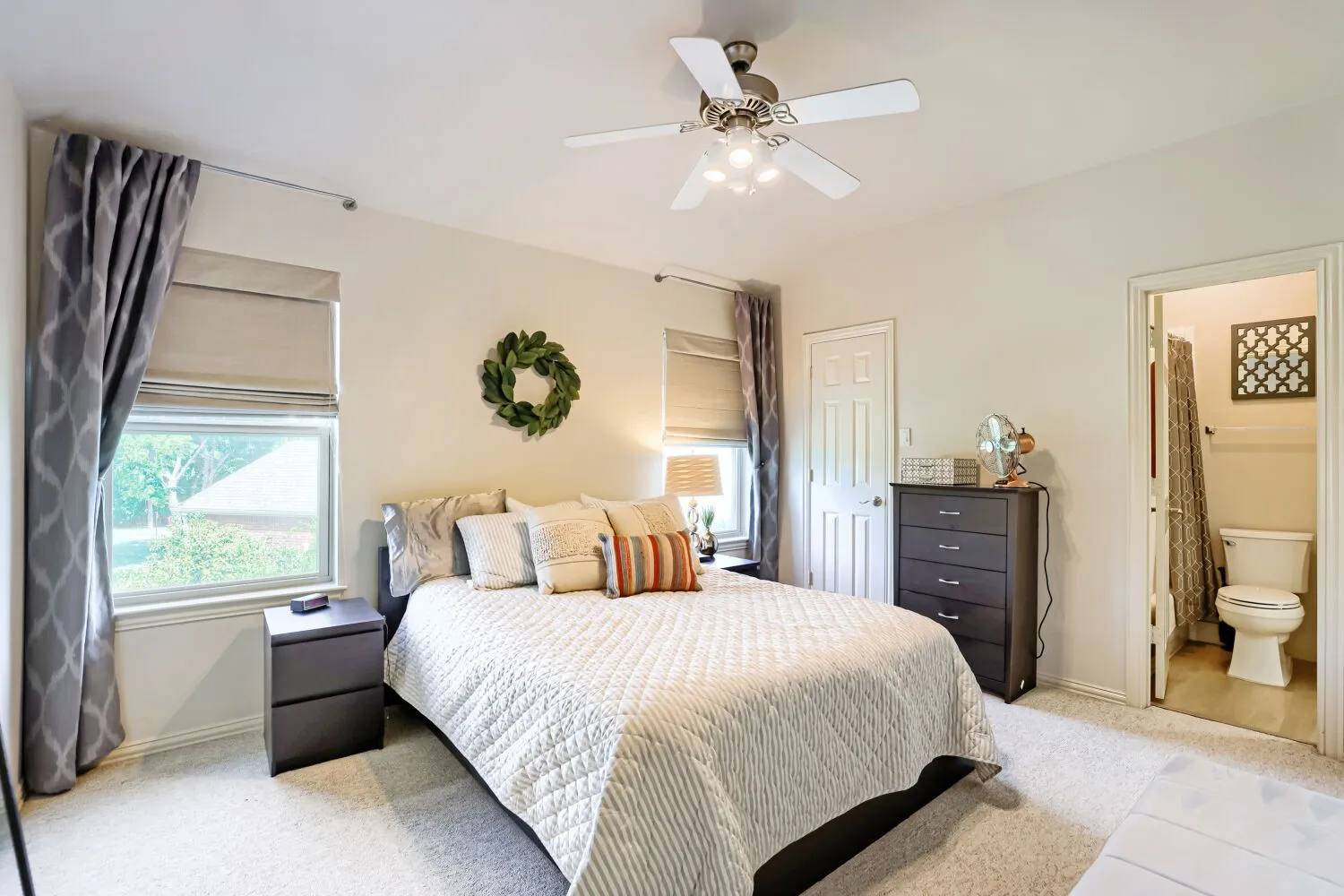 Second-floor bedroom featuring a walk-in closet and en-suite bathroom.
