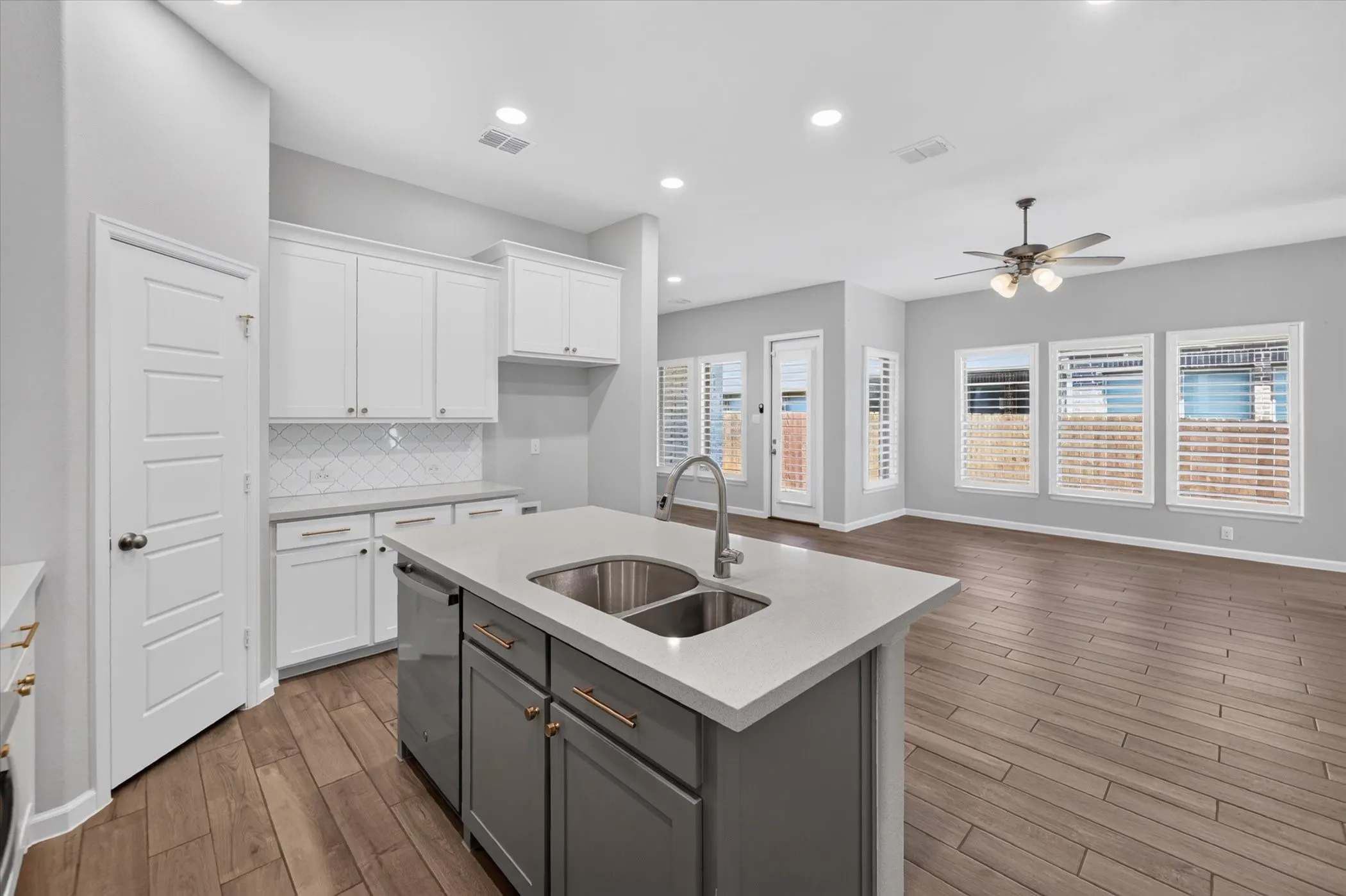 Kitchen island with dual stainless steel sinks and a chrome faucet