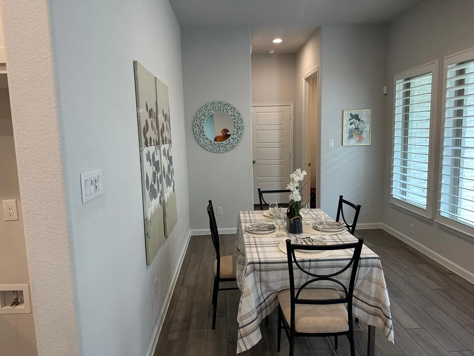 Wood-finish flooring, recessed lighting, and multiple windows with plantation shutters