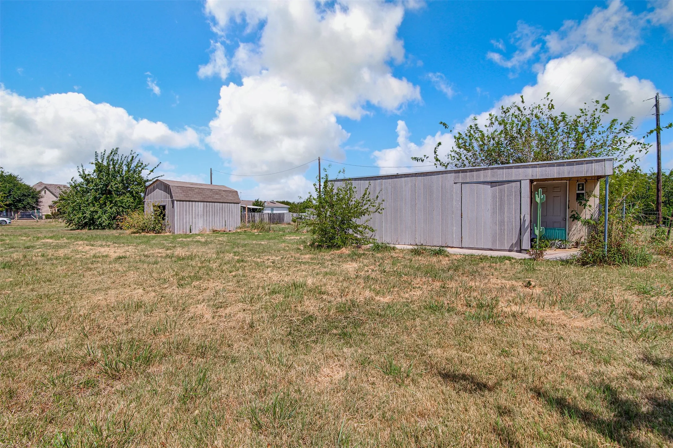 Detached storage shed and a separate outbuilding with an entry door