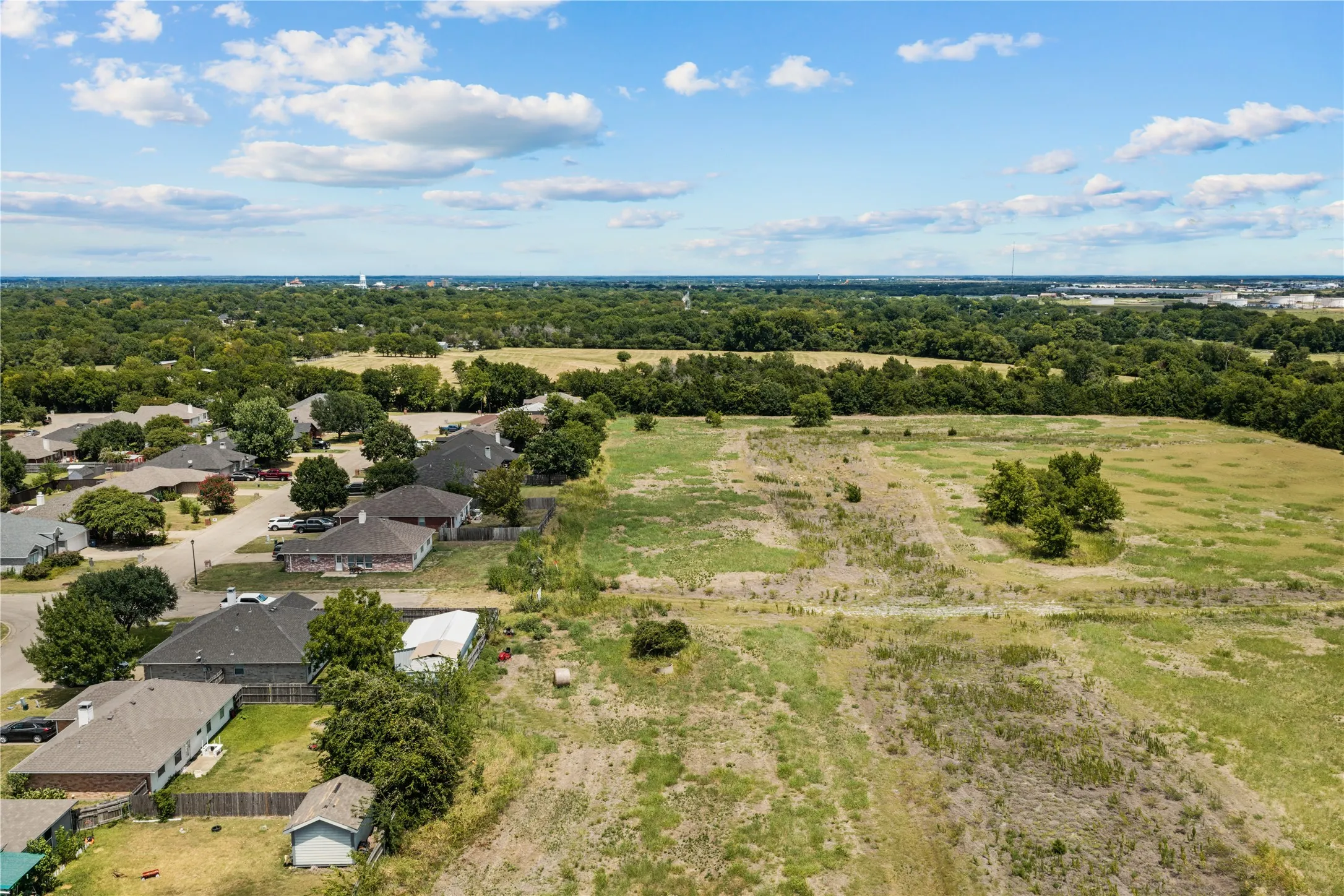 Expansive land parcel featuring open fields and scattered trees