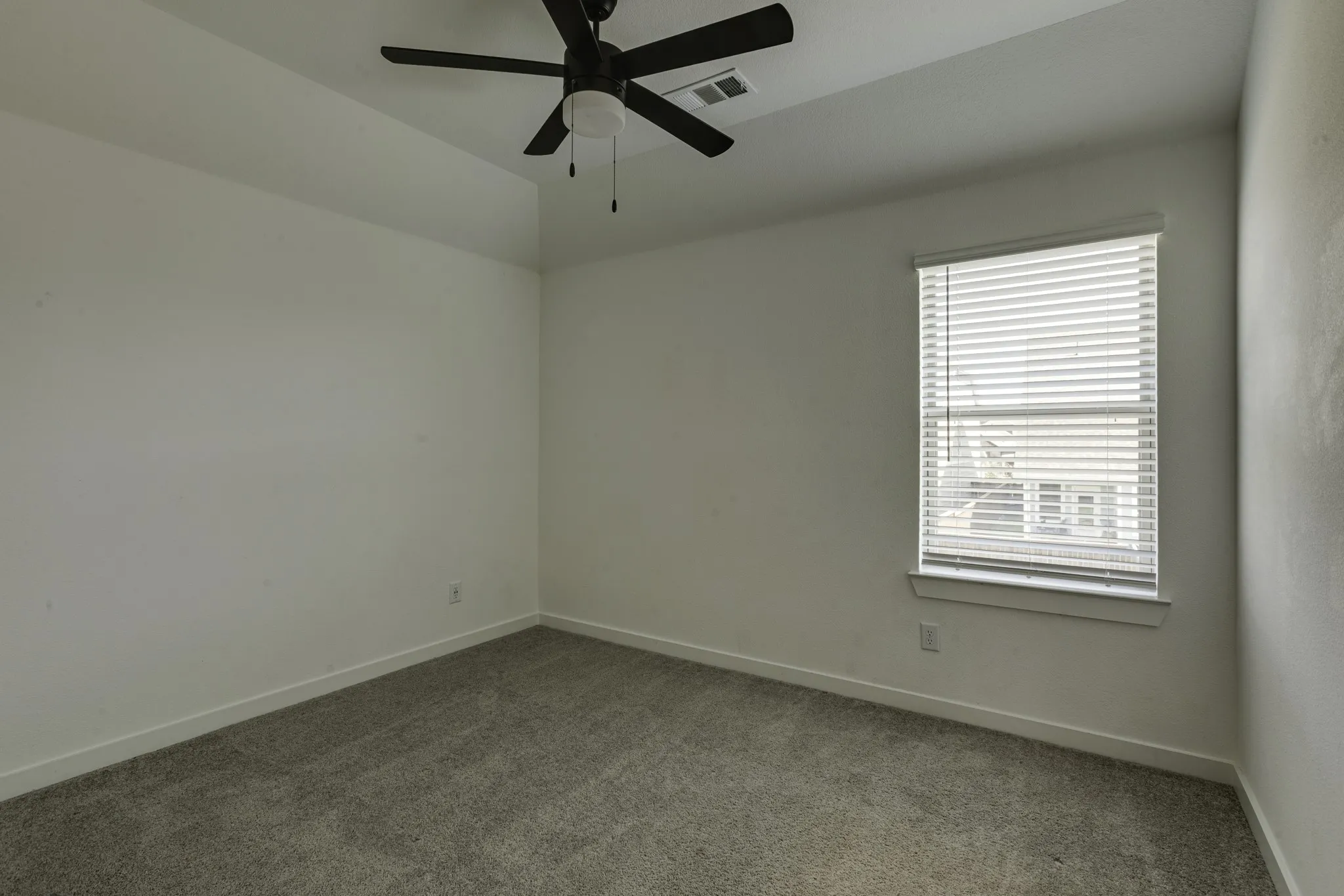 Upstairs bedroom #3, with recessed ceiling with an integrated ceiling fan, a window with blinds, and carpet flooring