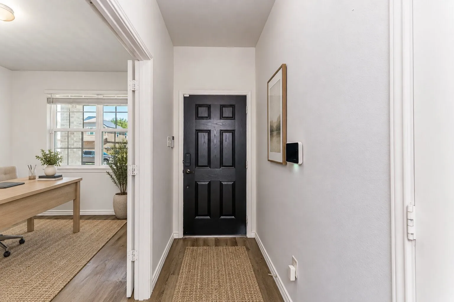 *virtually staged* Black paneled entry door with smart lock system