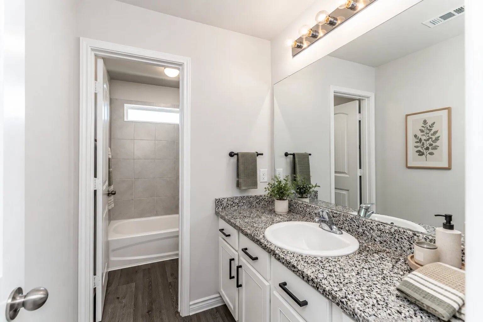 *virtually staged* Vanity with granite-look countertop, undermount sink, and black hardware cabinetry